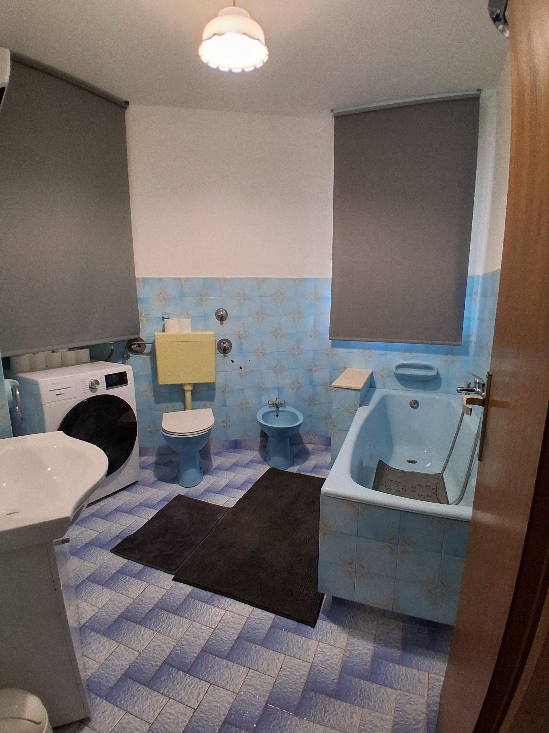 Blue tiled bathroom with tub