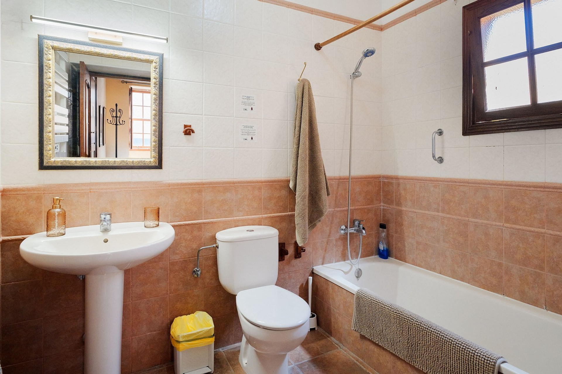 Bathroom with bathtub and pedestal sink