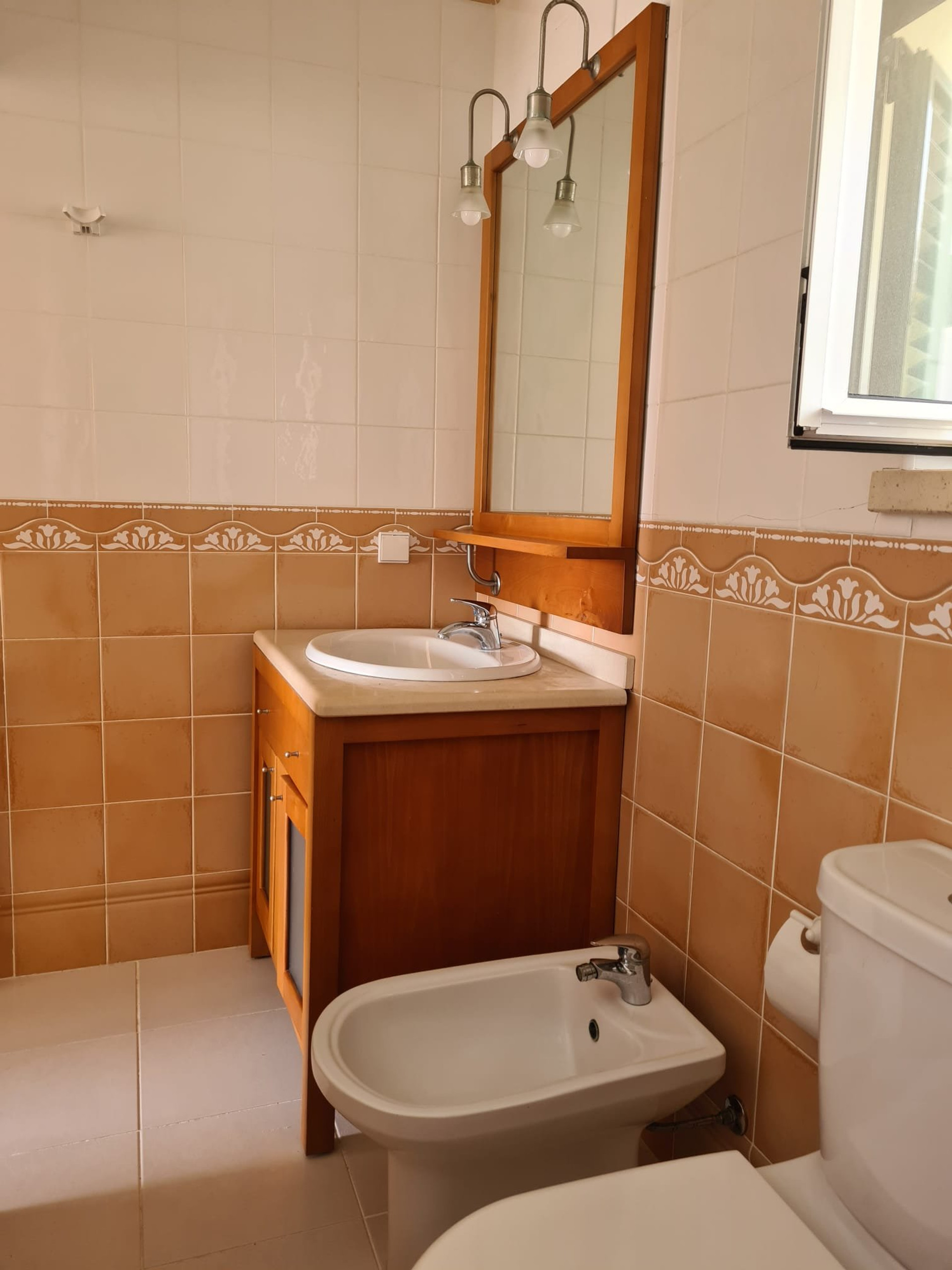 Bathroom with vanity and bidet