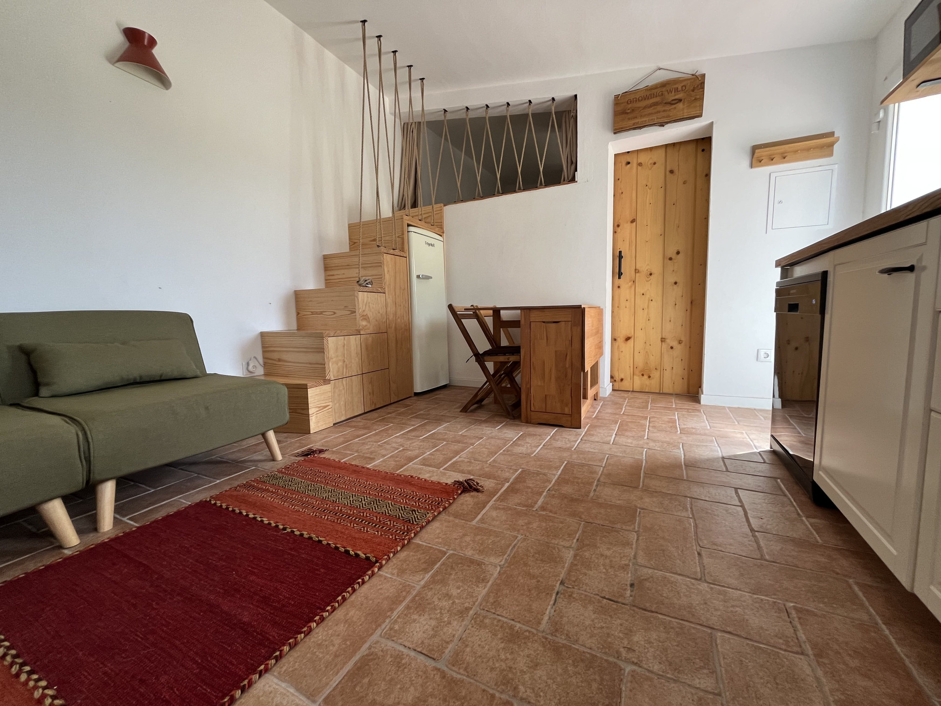 Living room with stairs and kitchenette