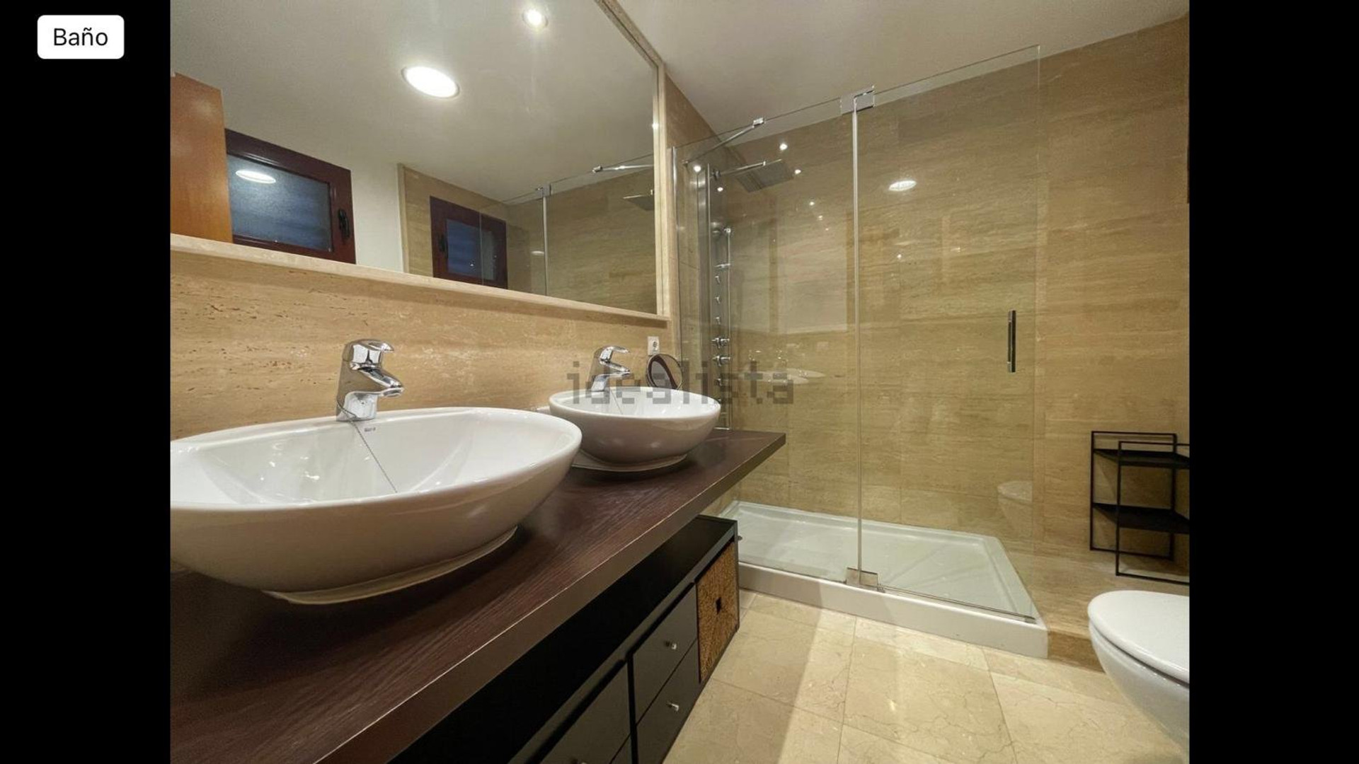 Bathroom with double sinks and shower