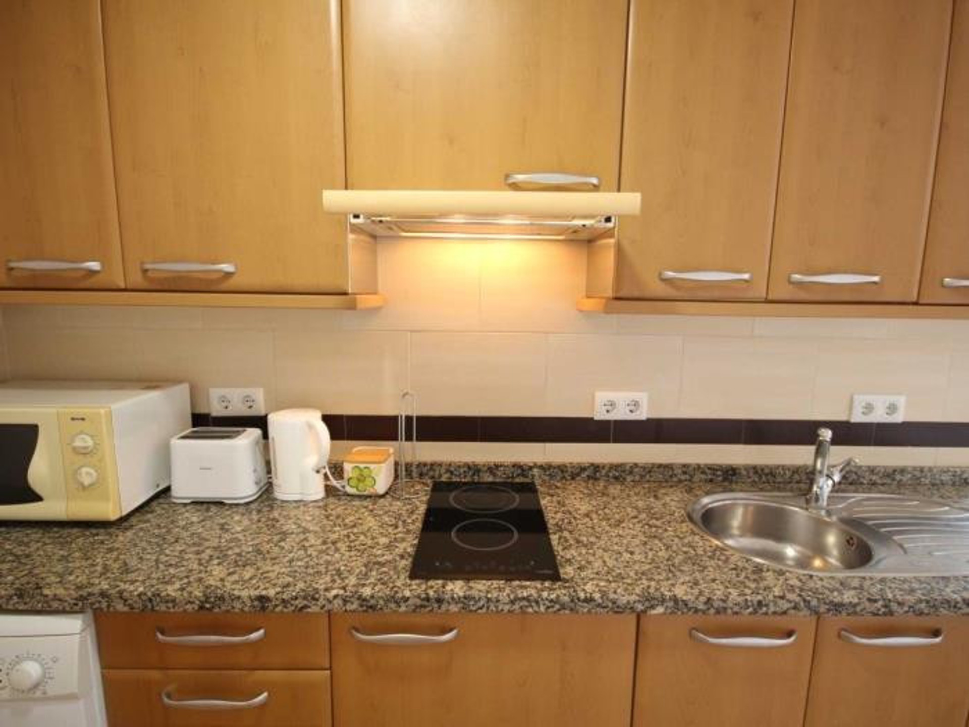 Kitchen counter with stove and sink