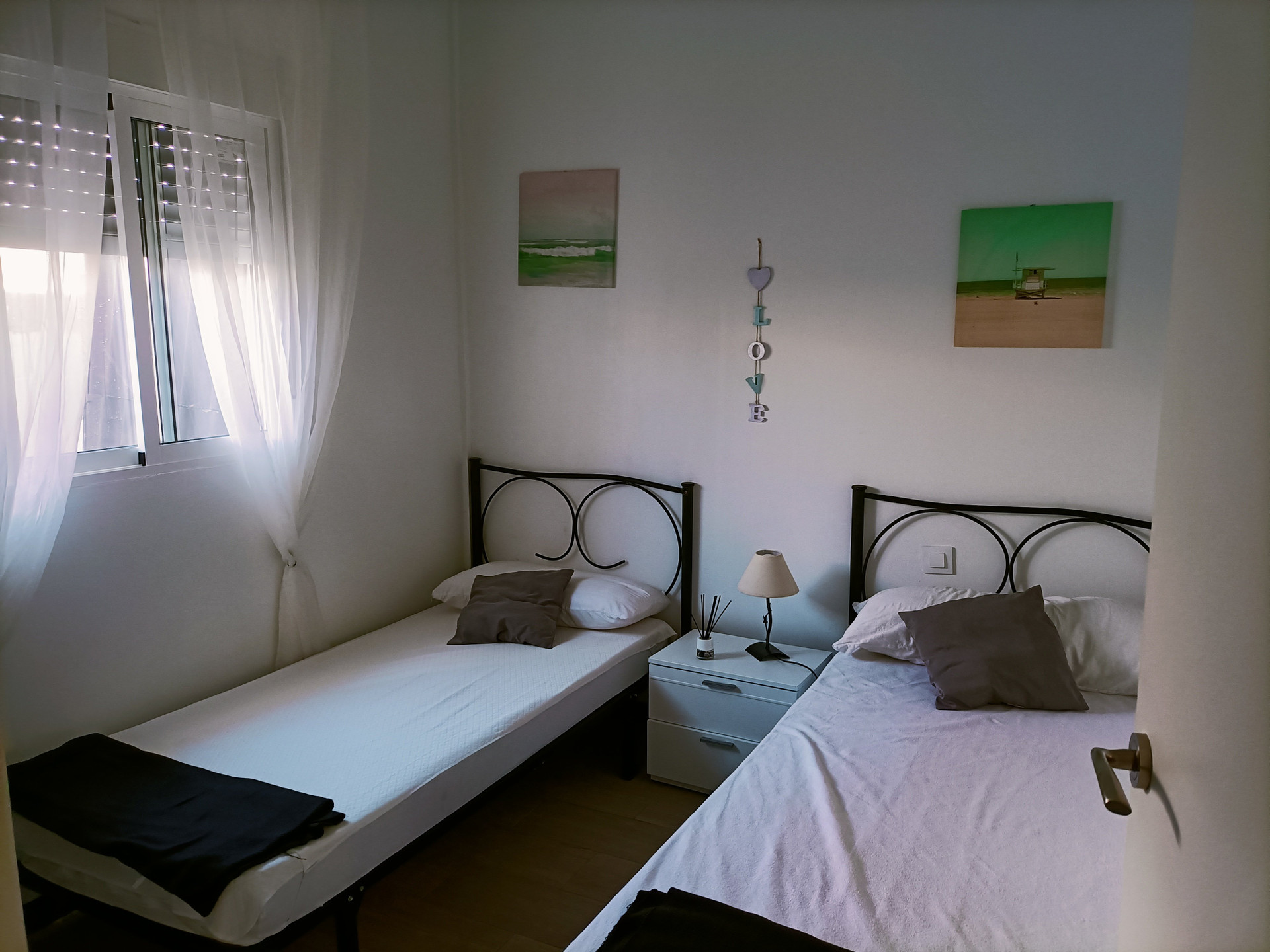 Twin bedroom with beach art