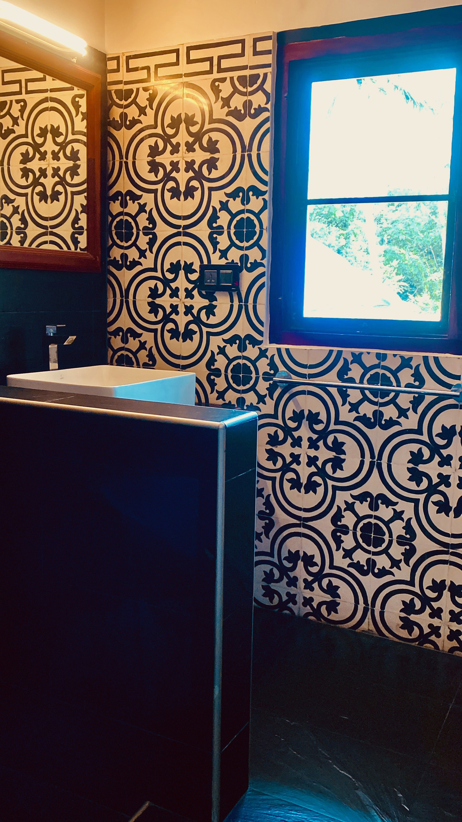 Bathroom with patterned tiles and vanity