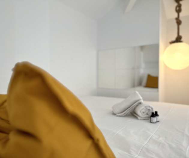 Bedroom bed with towels lamp