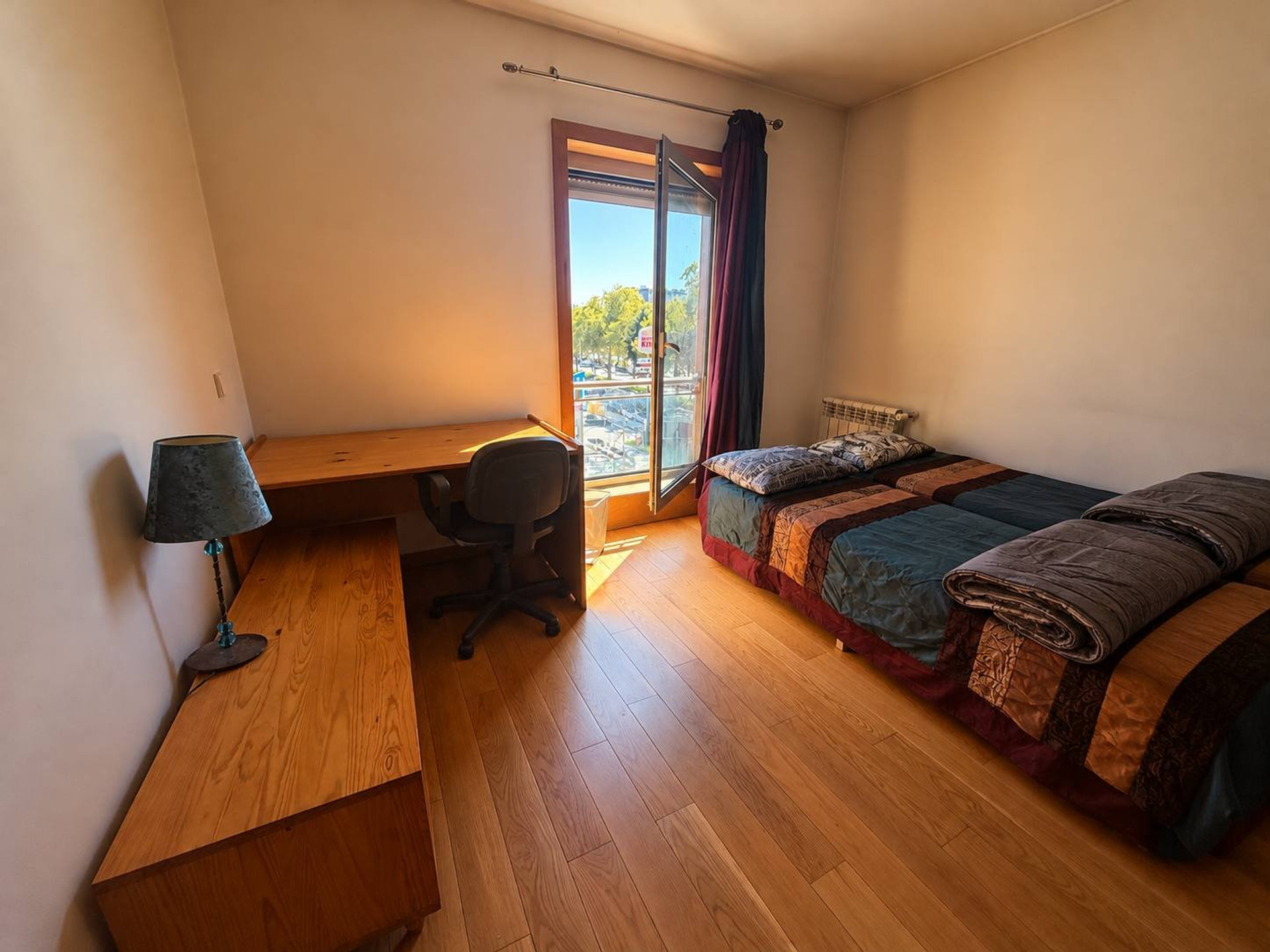 Bedroom with two beds and desk