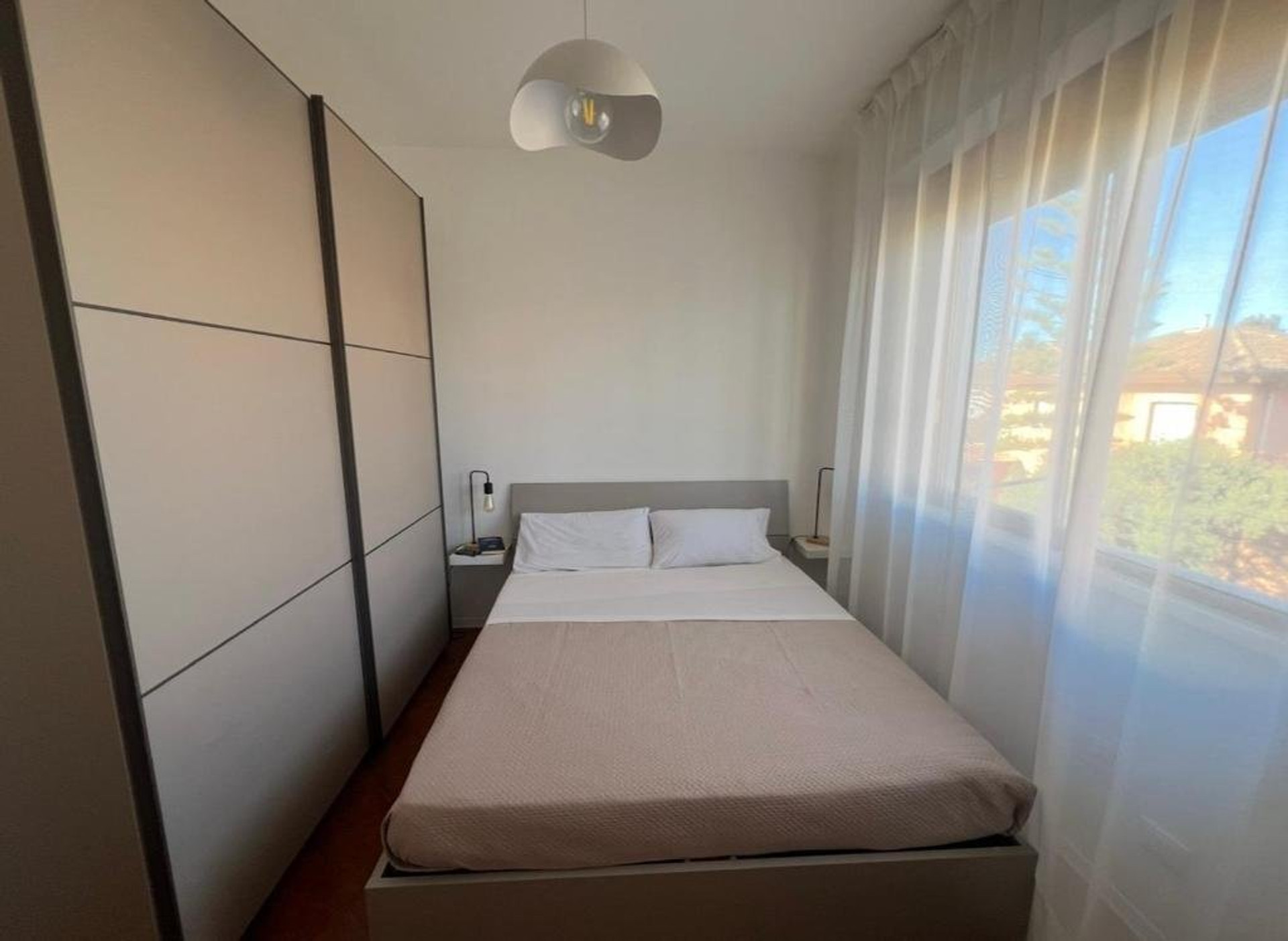 Cozy bedroom with wardrobe and window