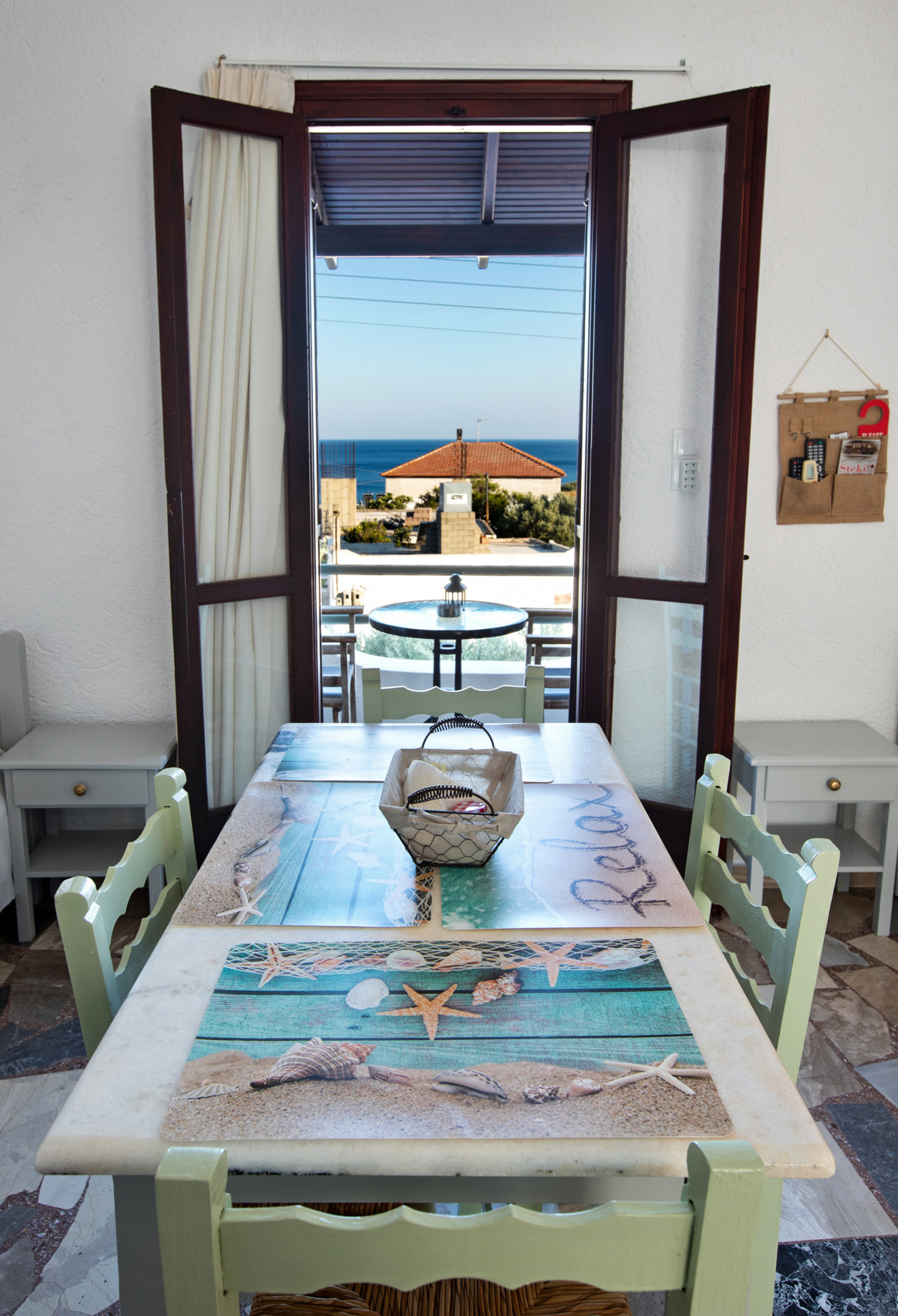View of the living room and balcony, both with table and chairs