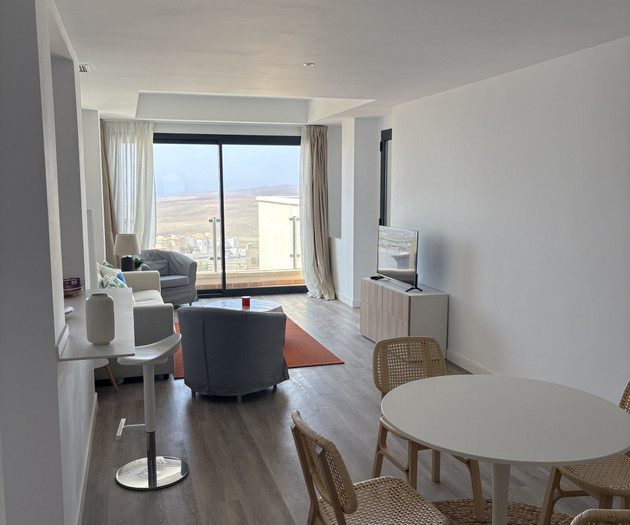 Living room with dining and balcony view