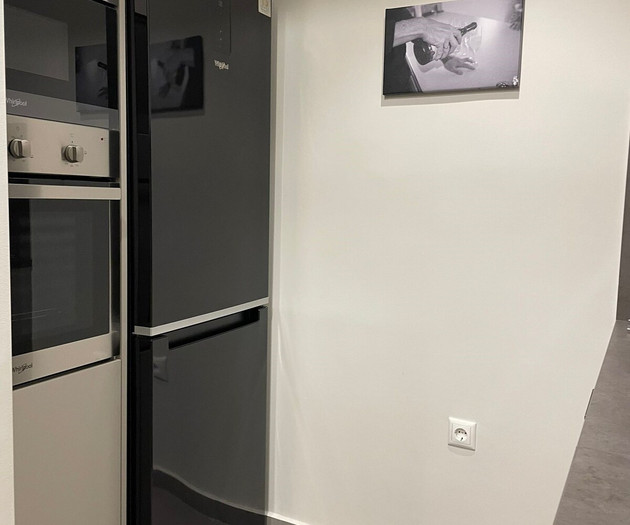 The kitchen's fridge and oven with microwave