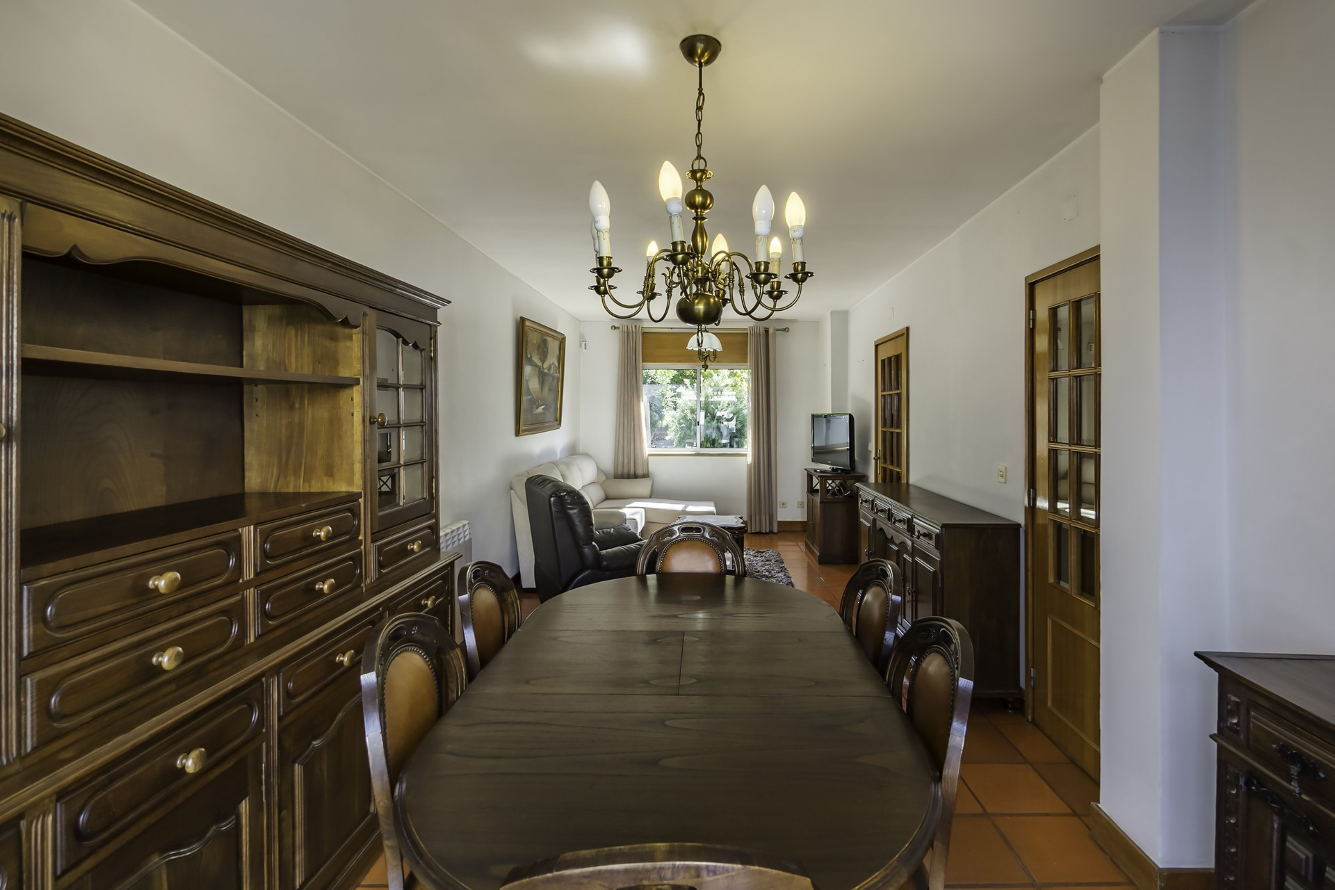 Dining and living area with chandelier