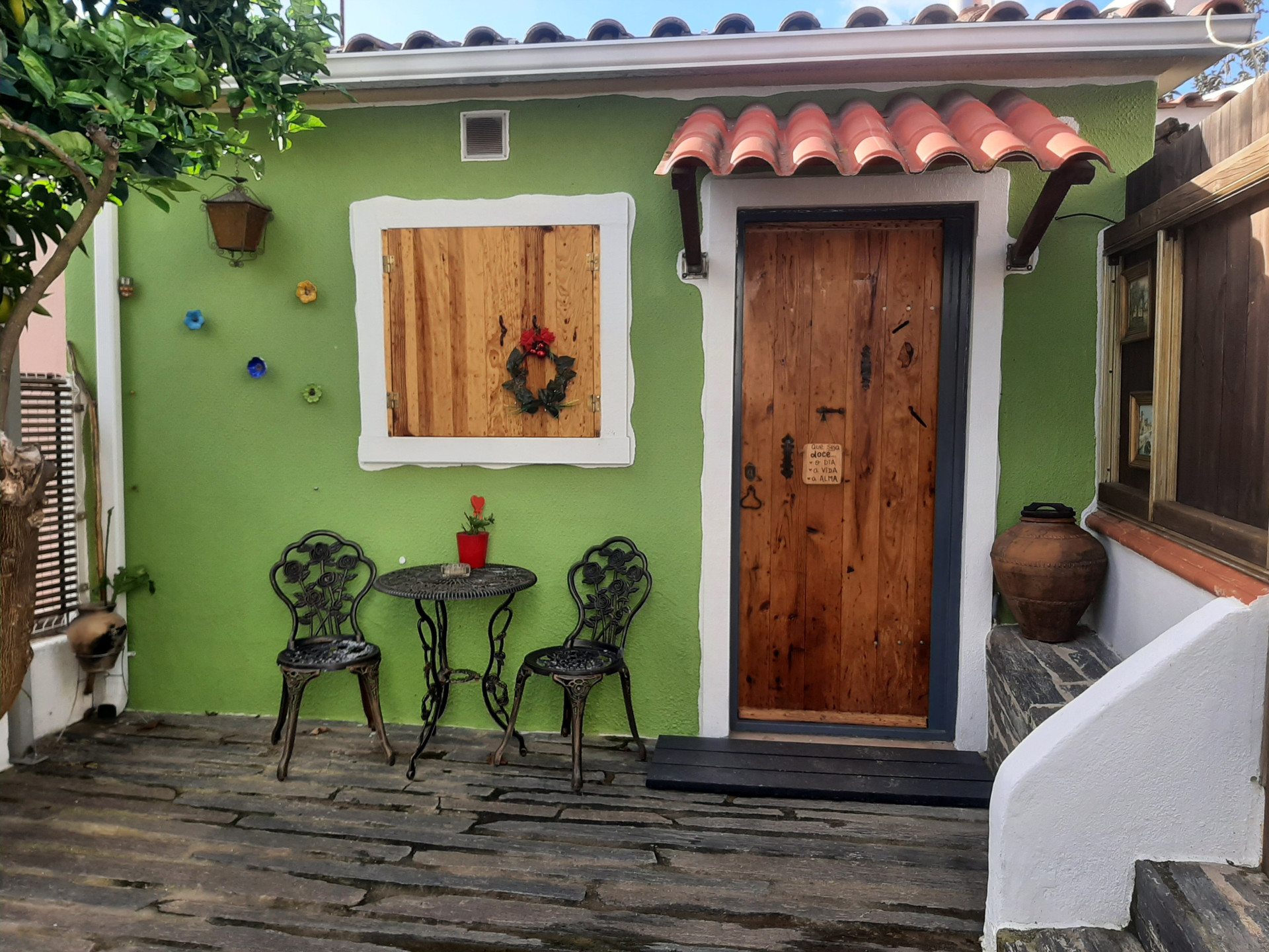 Charming green exterior with wooden door