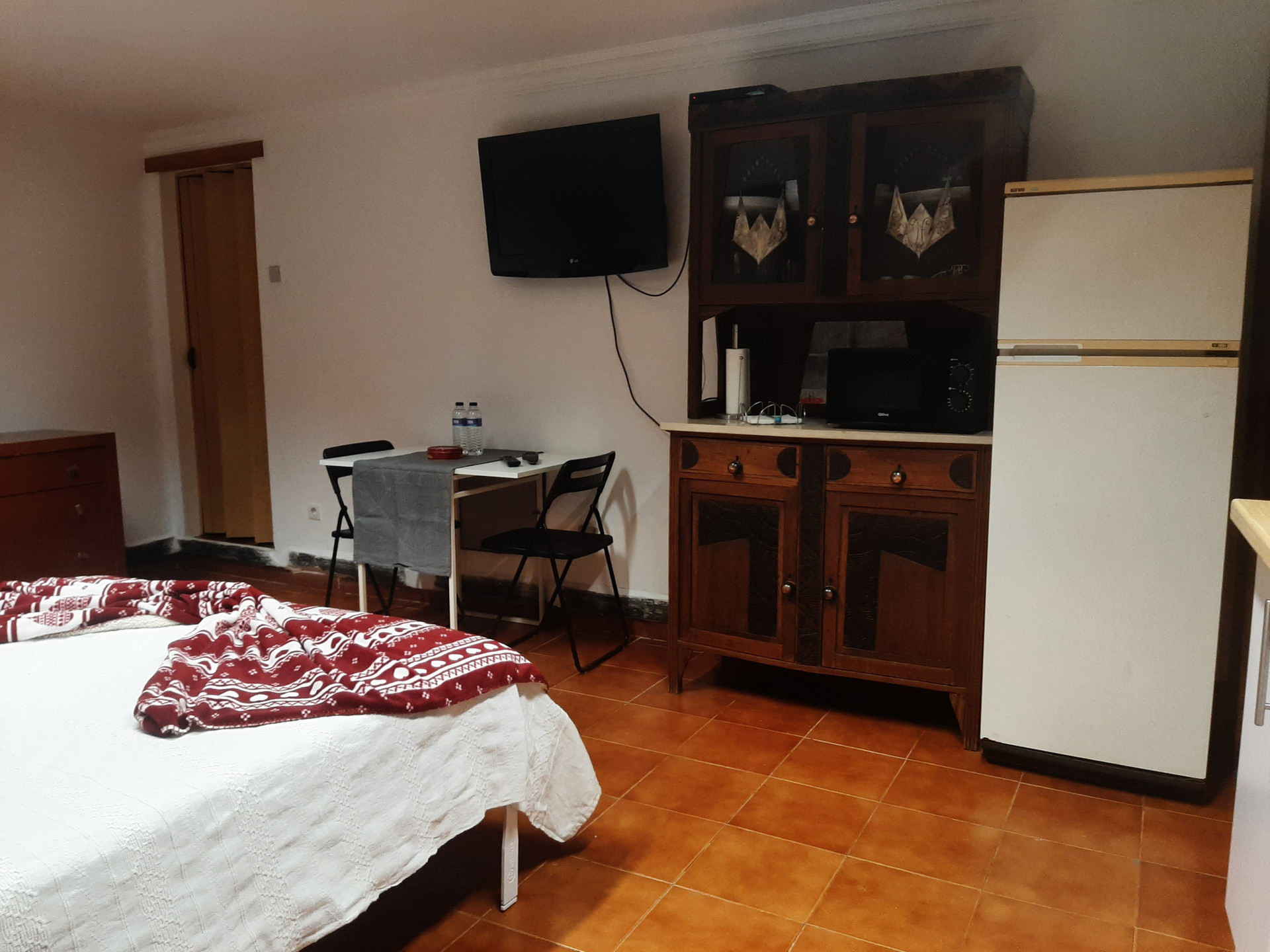 Bedroom with fridge and cabinet