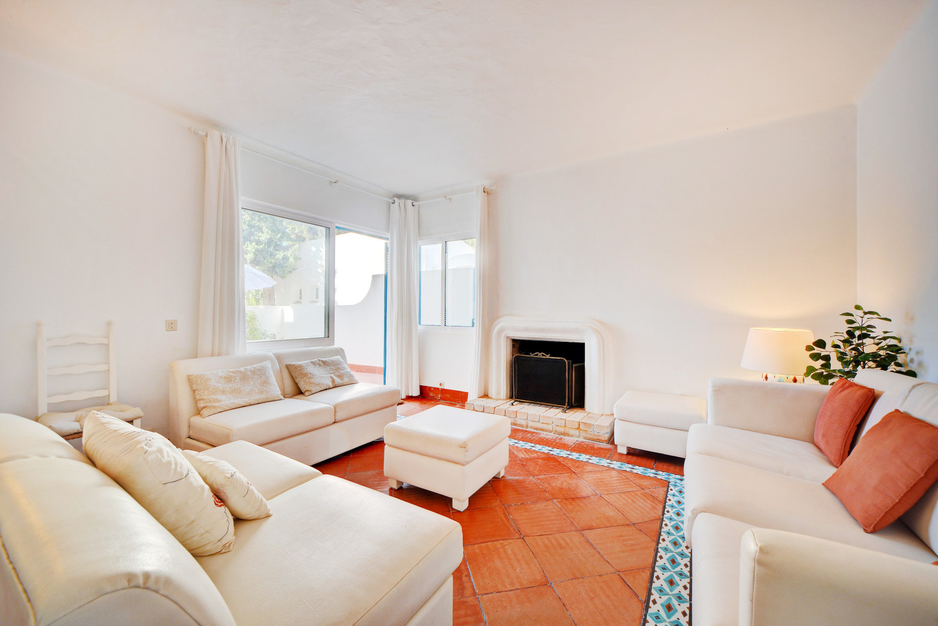 Living room with a sofa bed, wood-burning fireplace, and TV.
