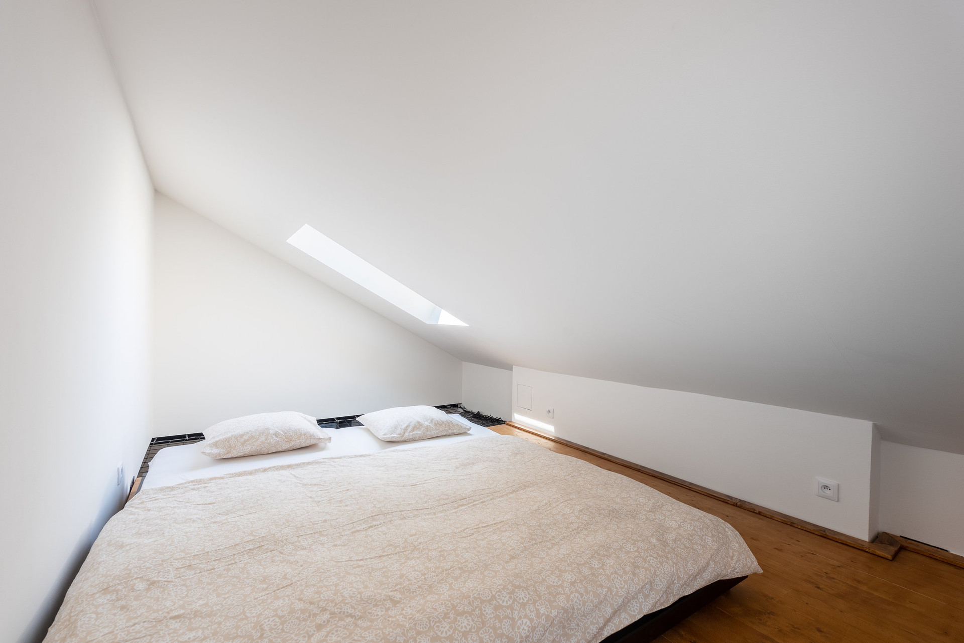 Loft bedroom with sloped ceiling