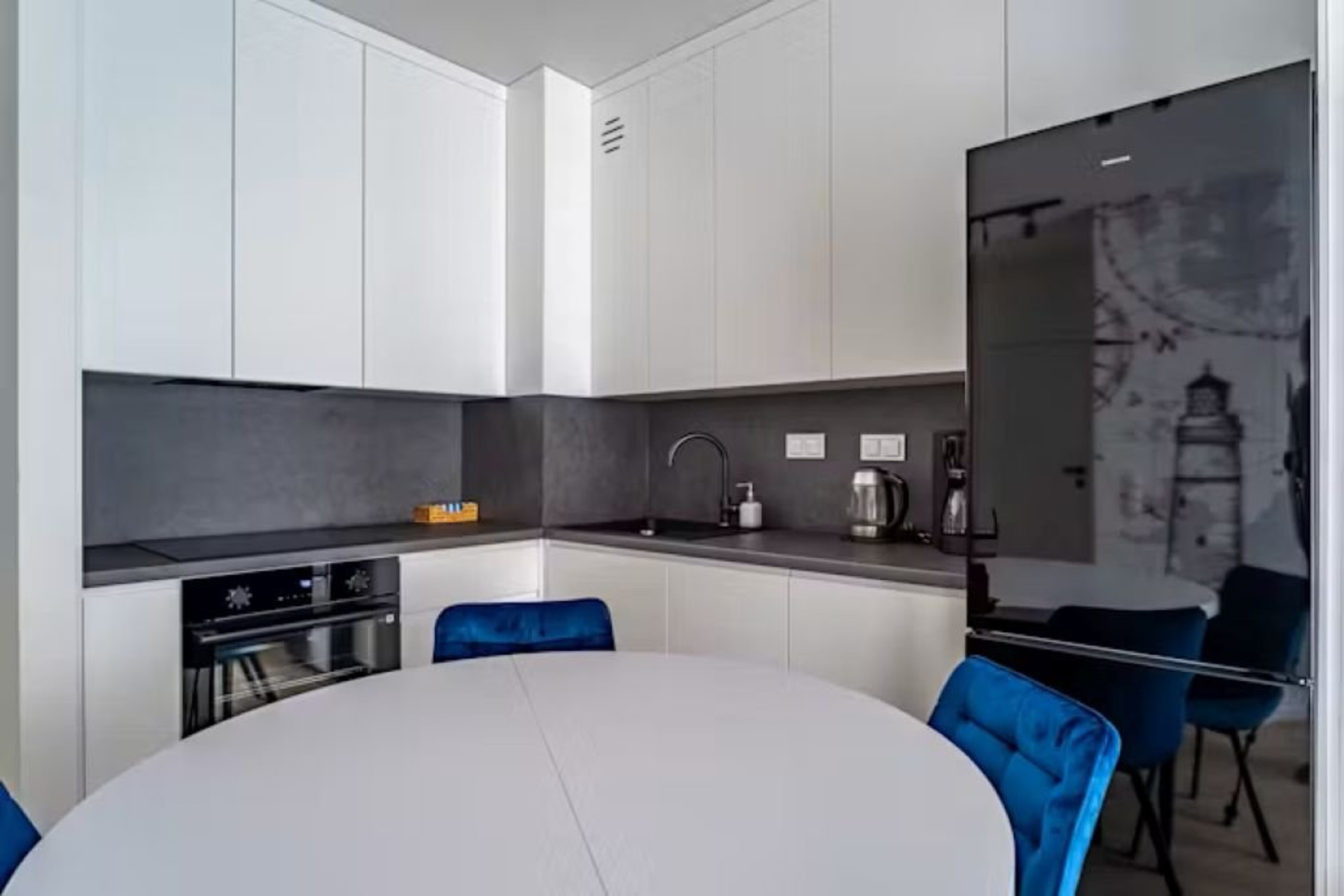 Modern kitchen with oven and fridge