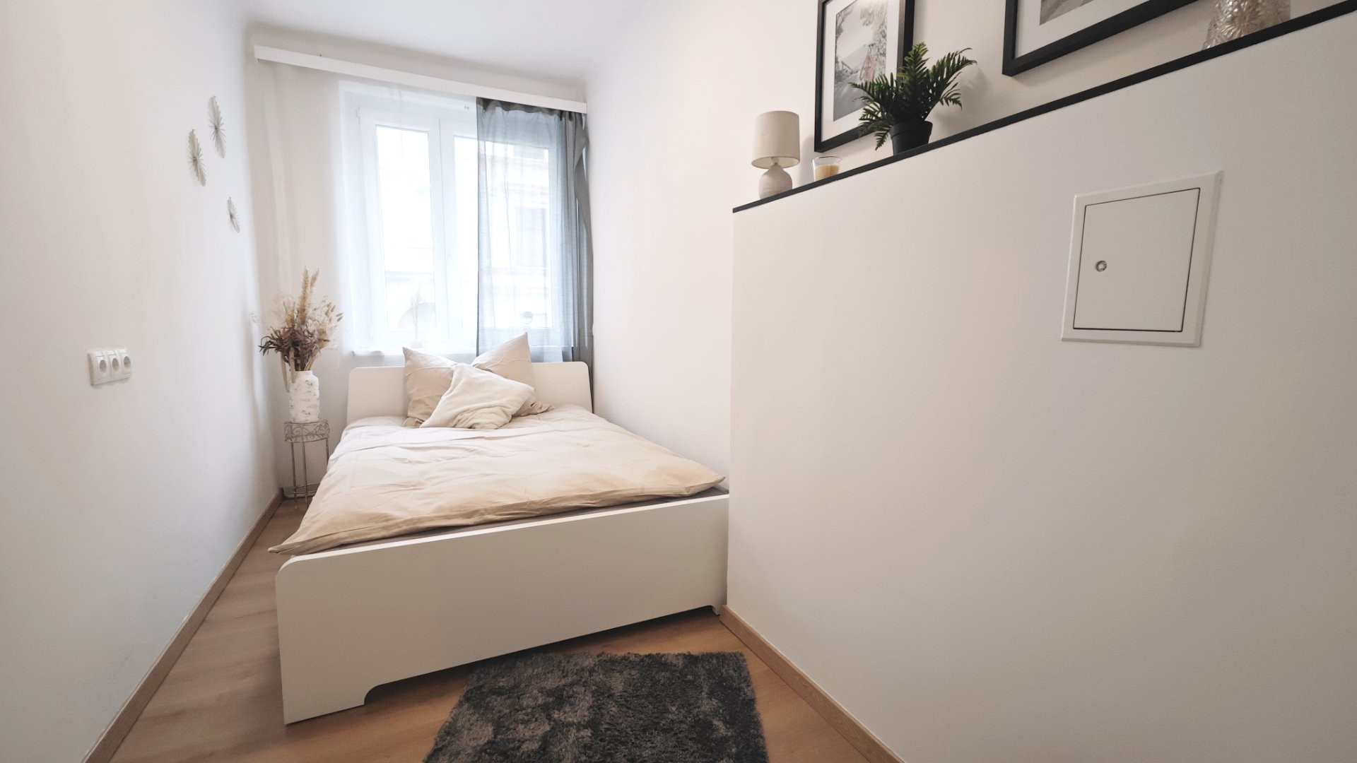 Bright bedroom with white double bed
