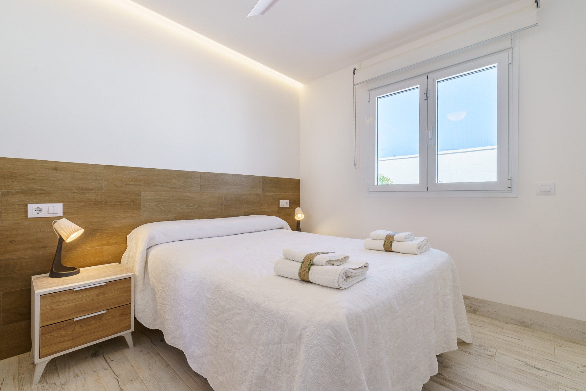 Double bedroom with wood headboard
