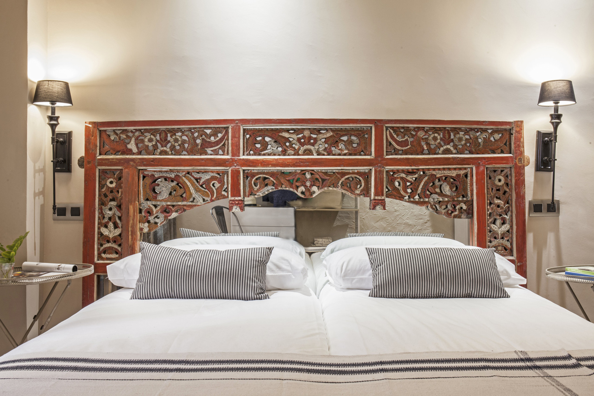 Bed with carved wooden headboard