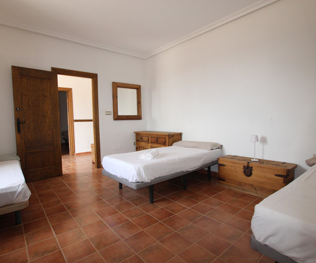 Bedroom with three beds