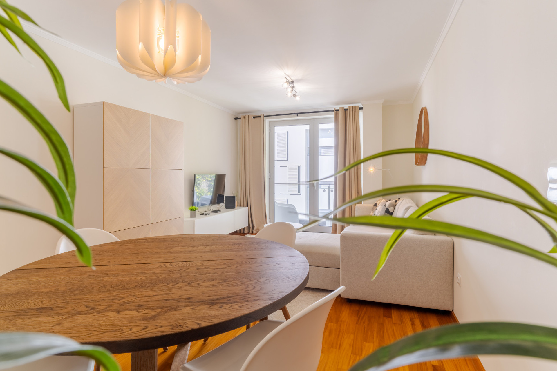 Living room with dinning table, sofa and television