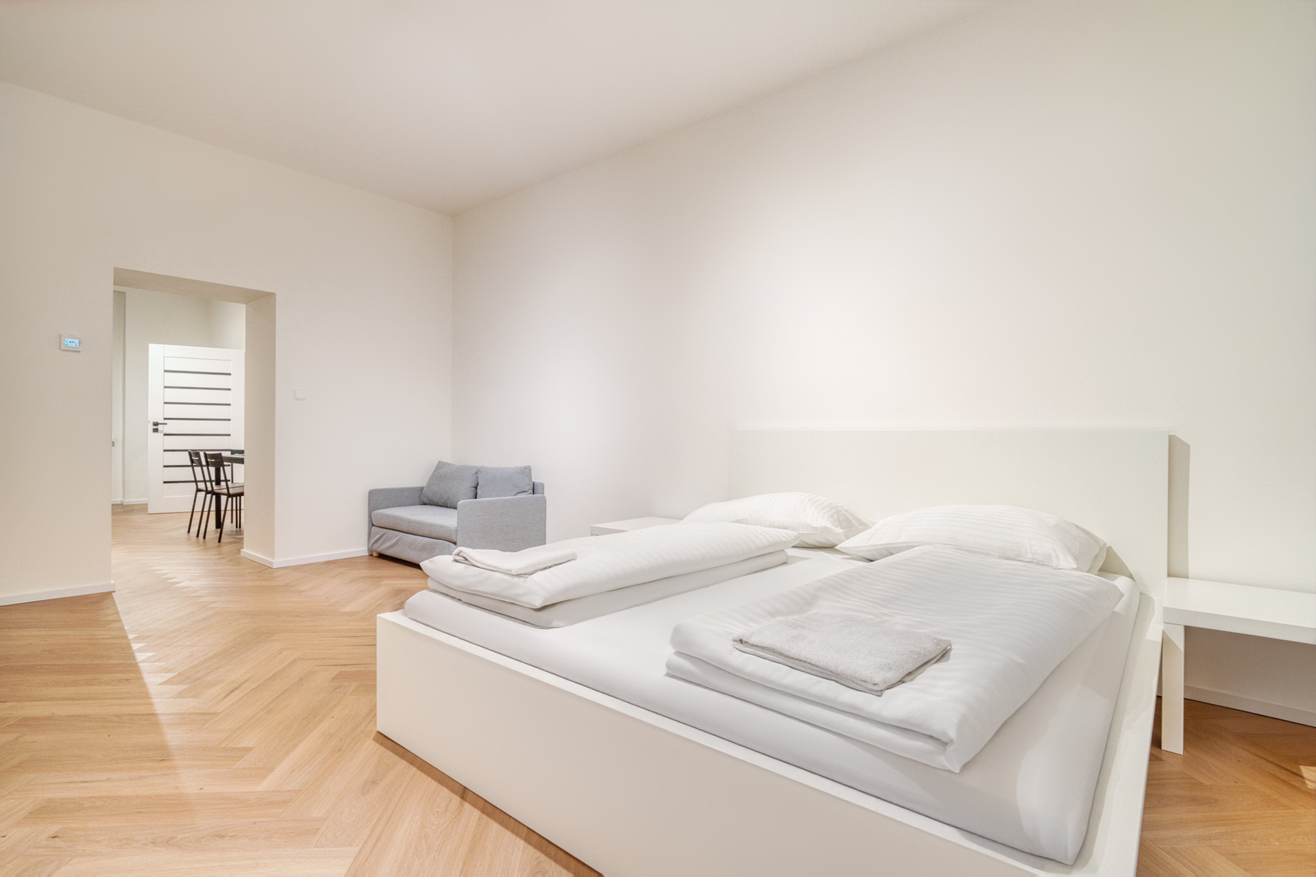 Bedroom with sofa and hallway view