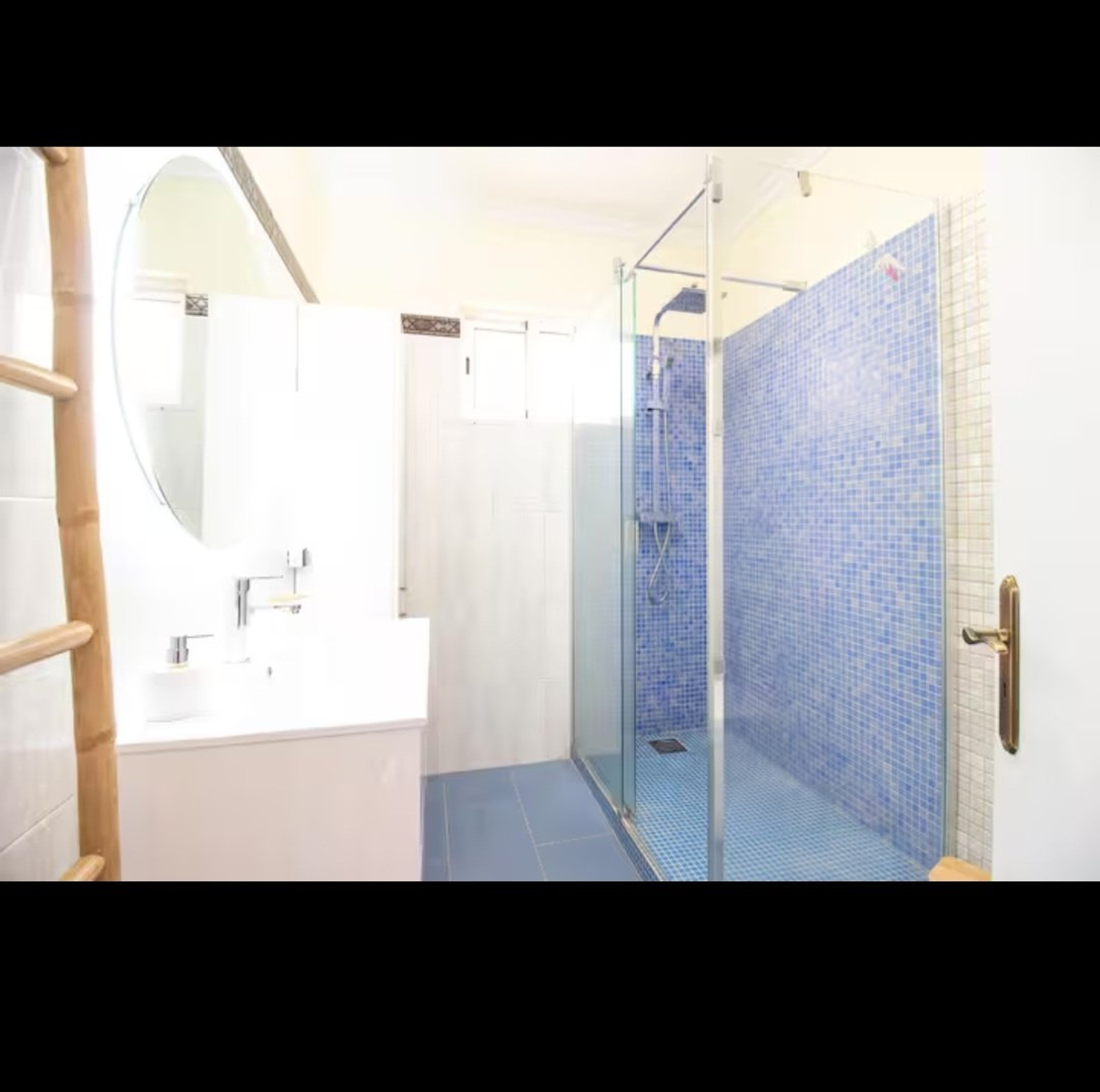 Bathroom with blue mosaic shower