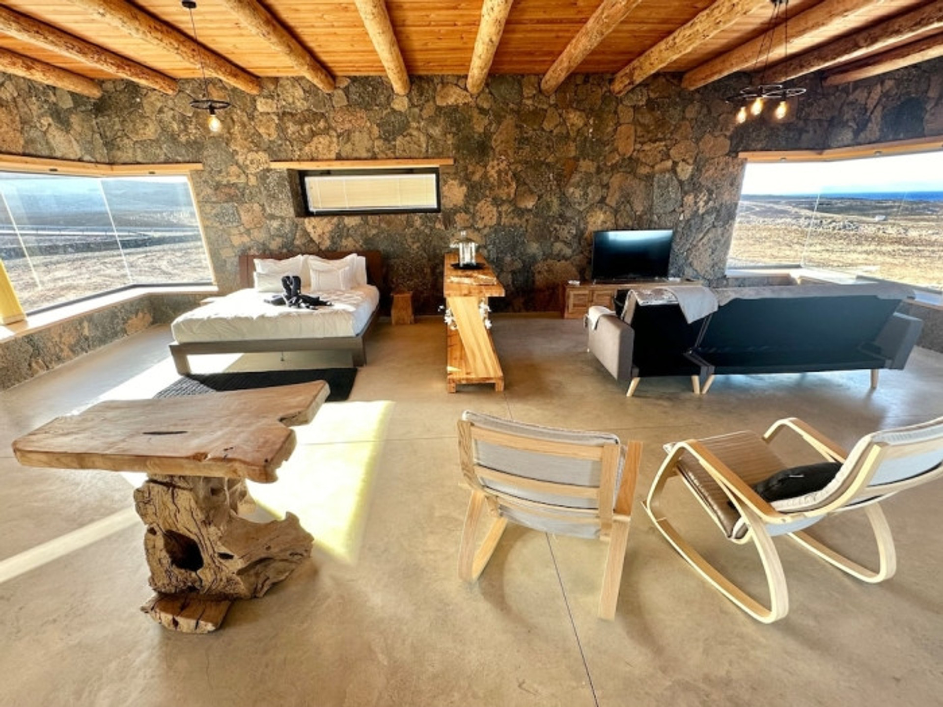Open plan bedroom living area stone walls