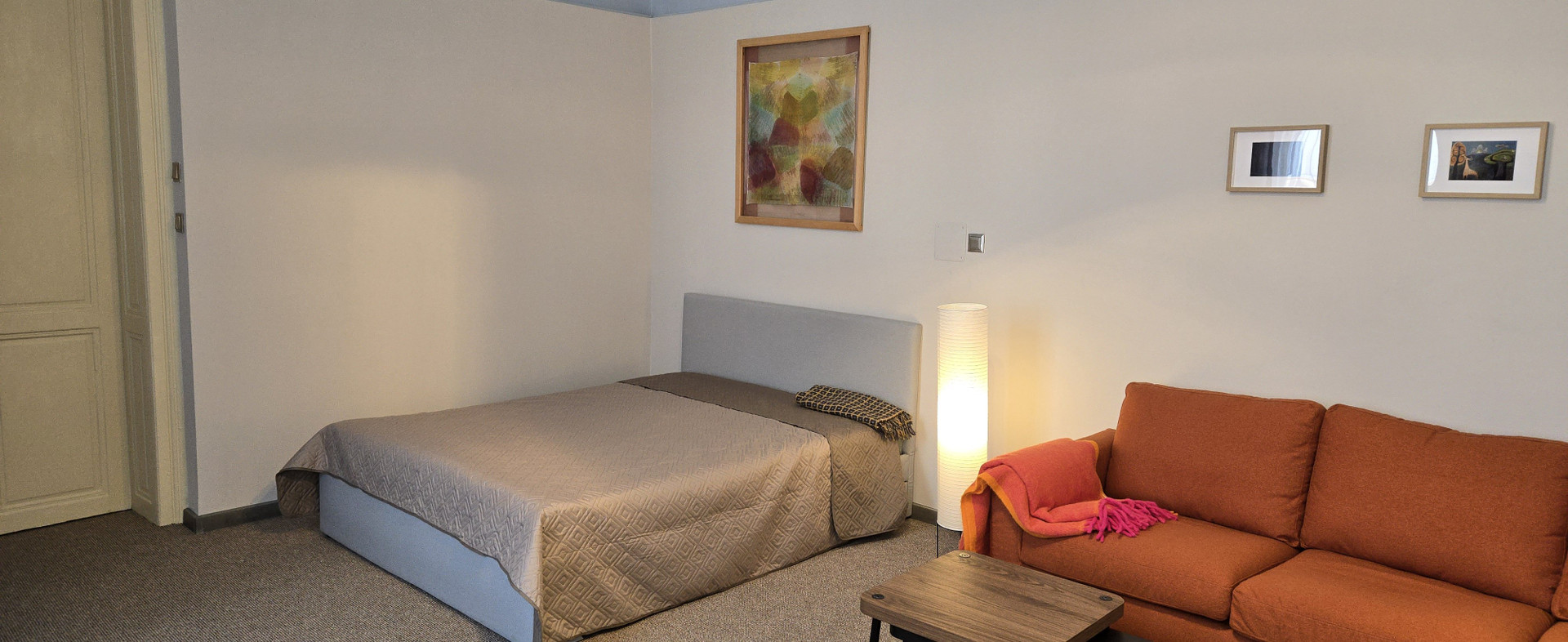 Bedroom with double bed and sofa