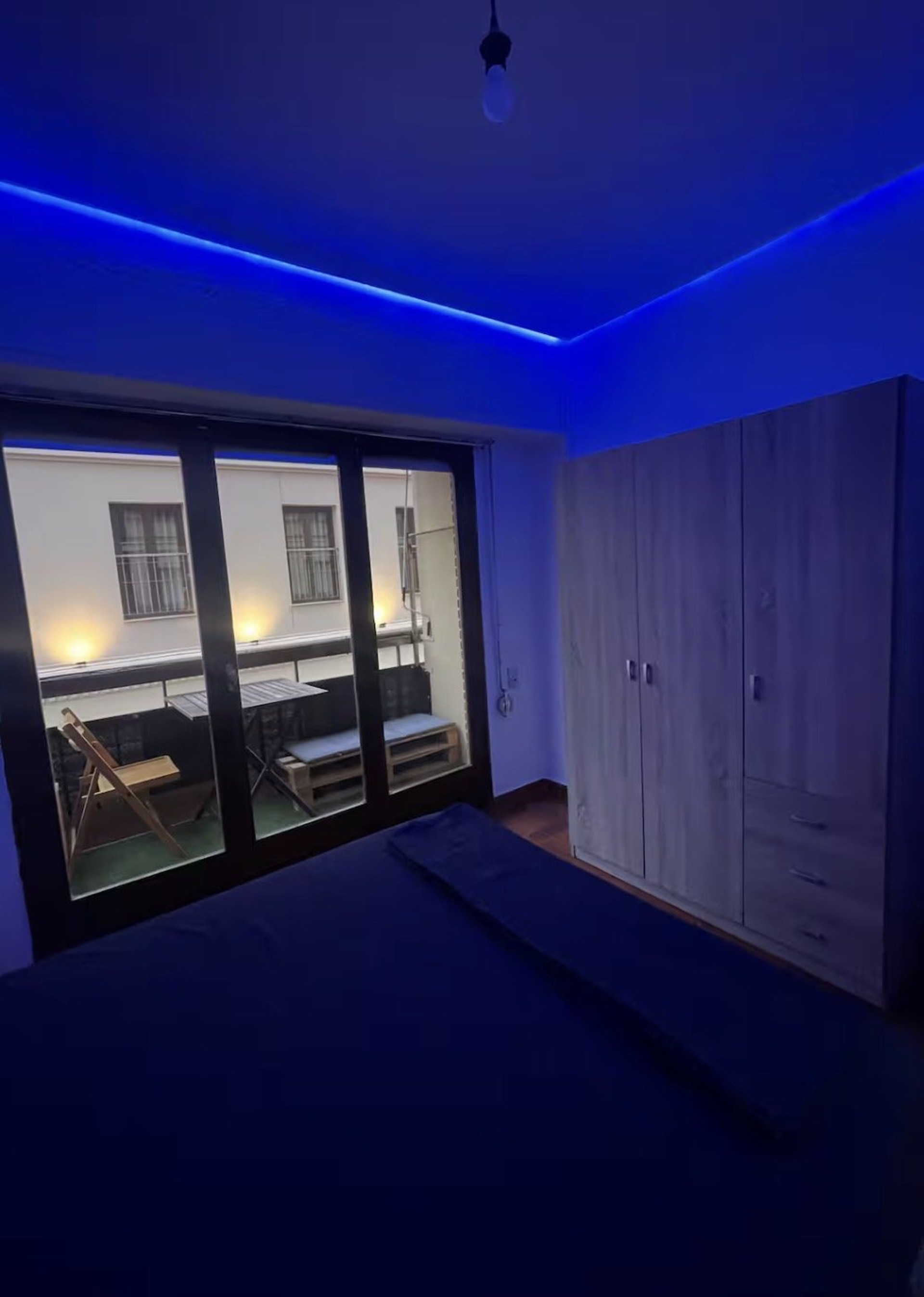 Bedroom with balcony access and wardrobe