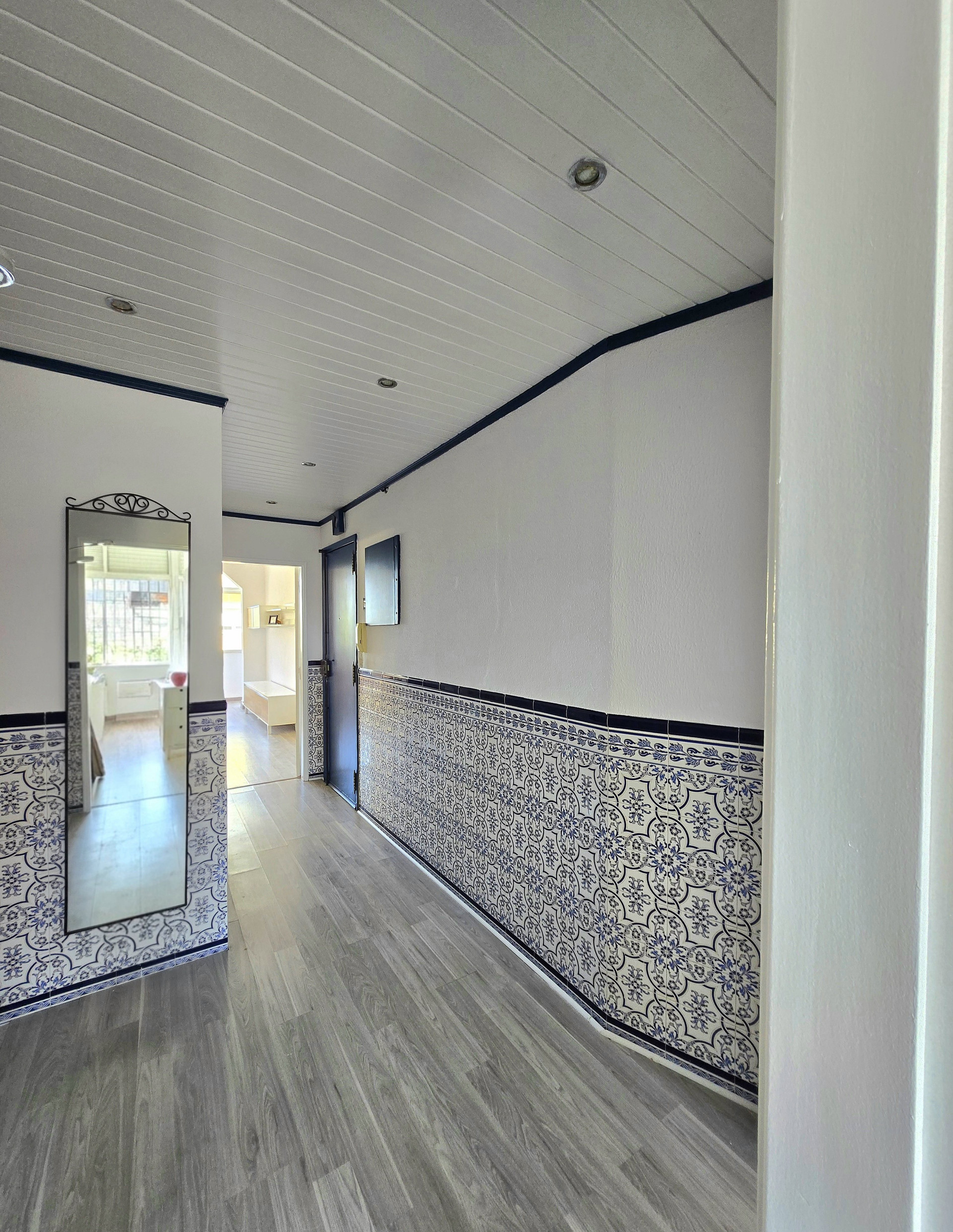 Tiled hallway entrance with mirror