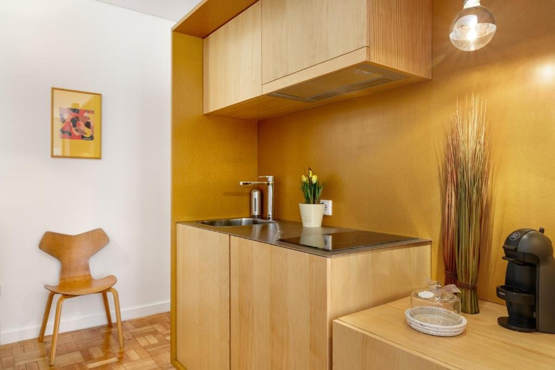 Yellow kitchenette with sink and coffee maker