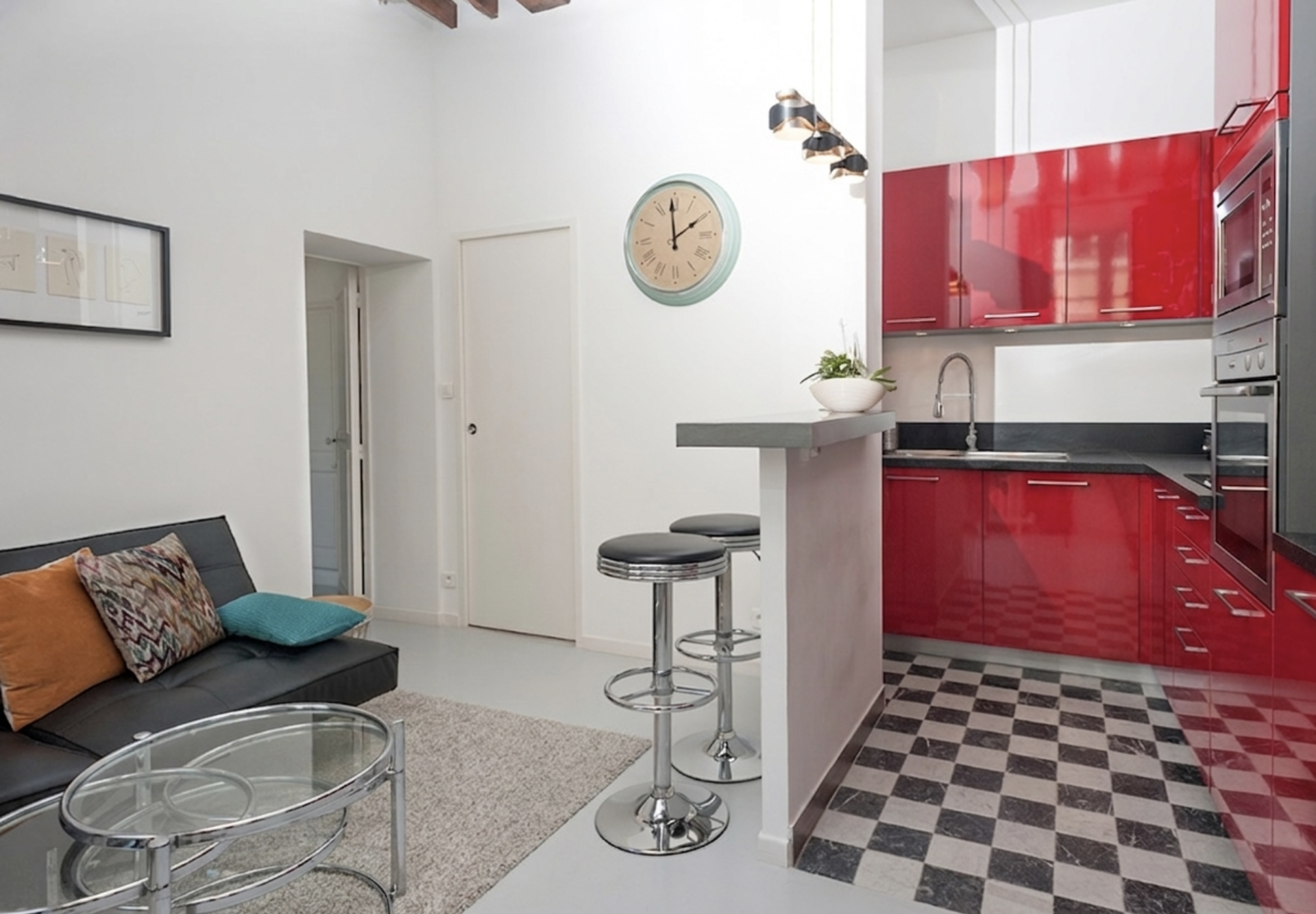 Bright open-concept space beautifully combining a modern kitchen and an elegant living area.