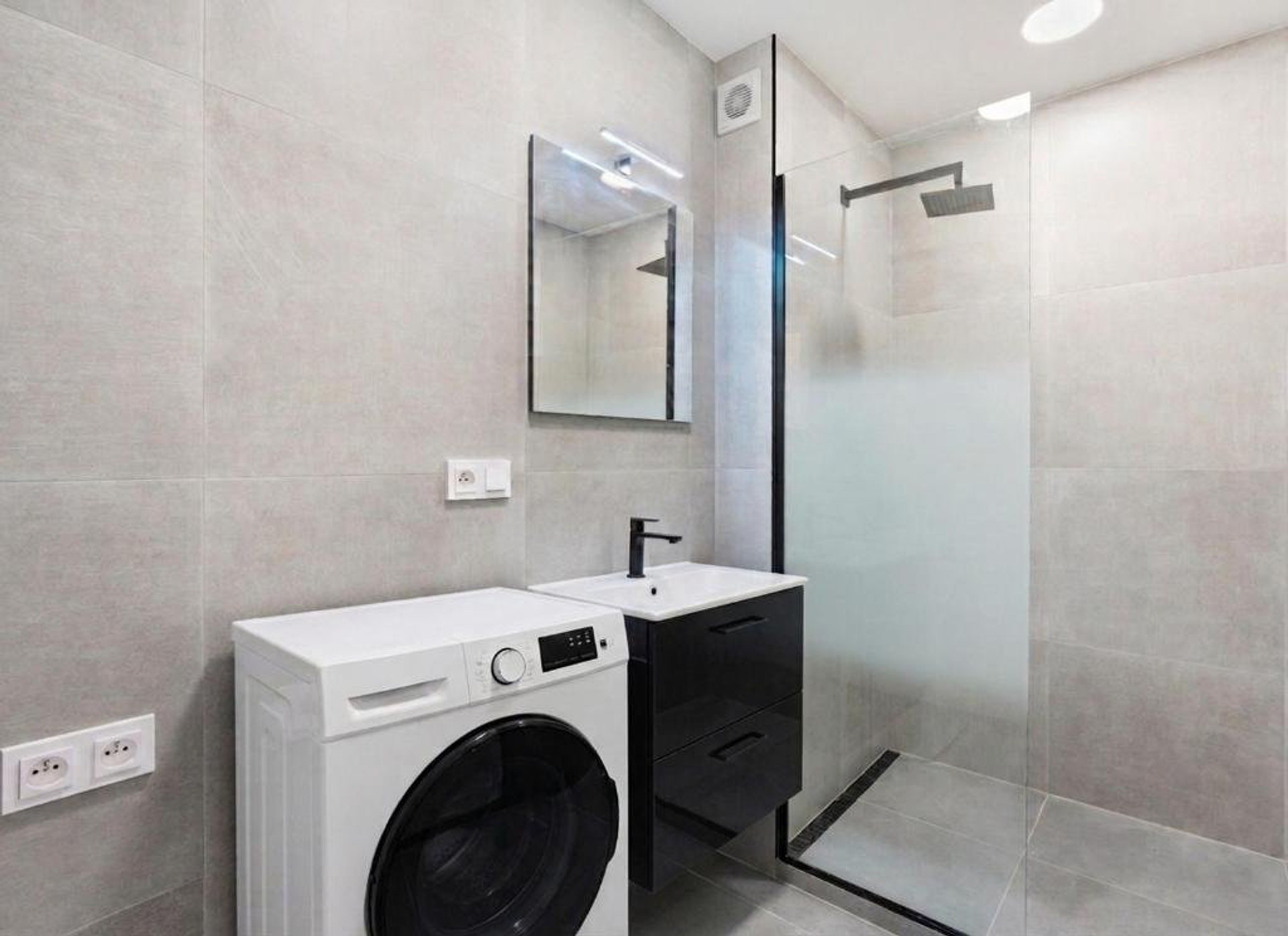 Modern bathroom with shower washing machine