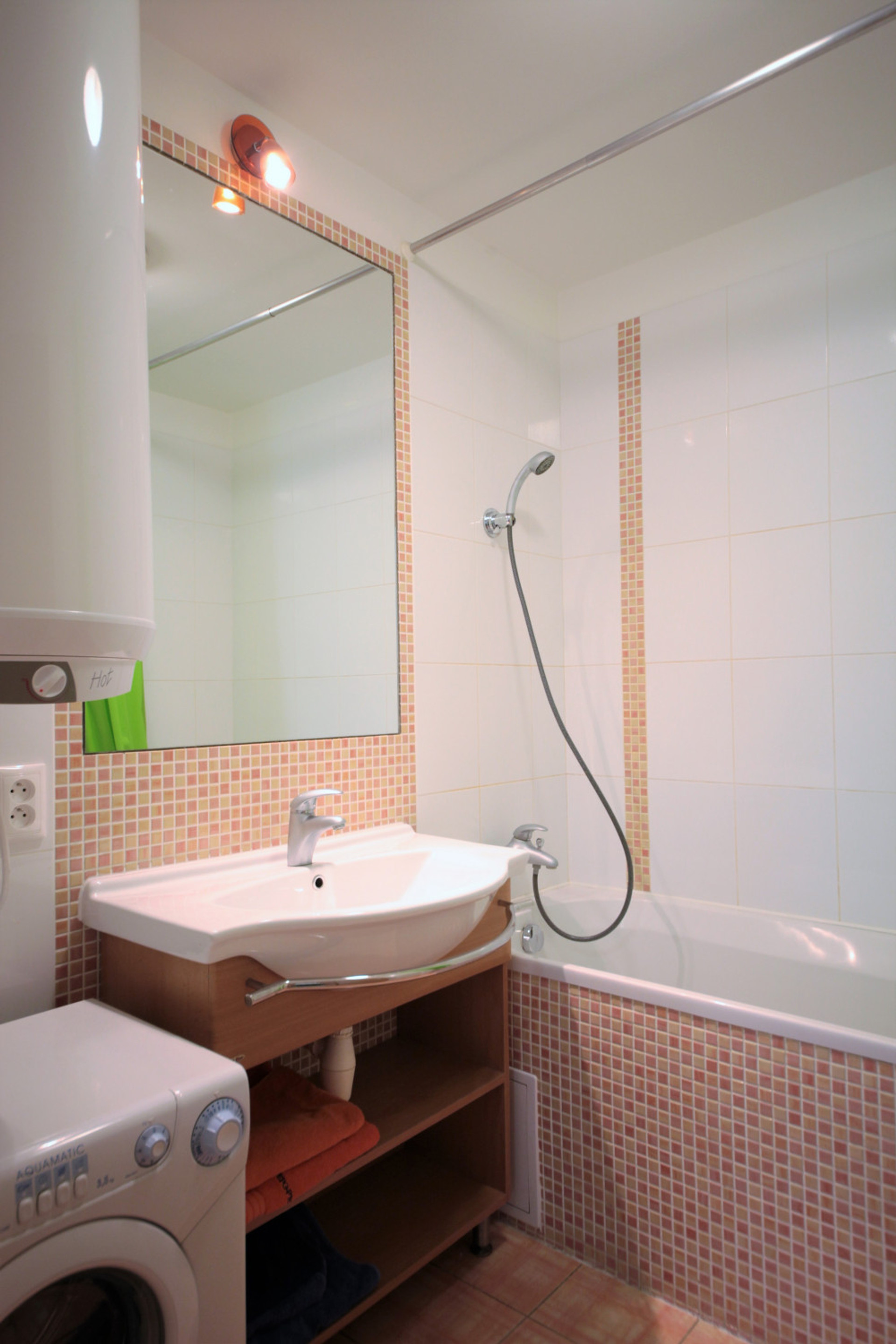 Bathroom with tub and washer