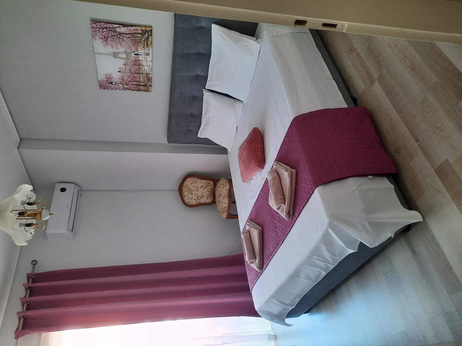 Bedroom with pink bedspread