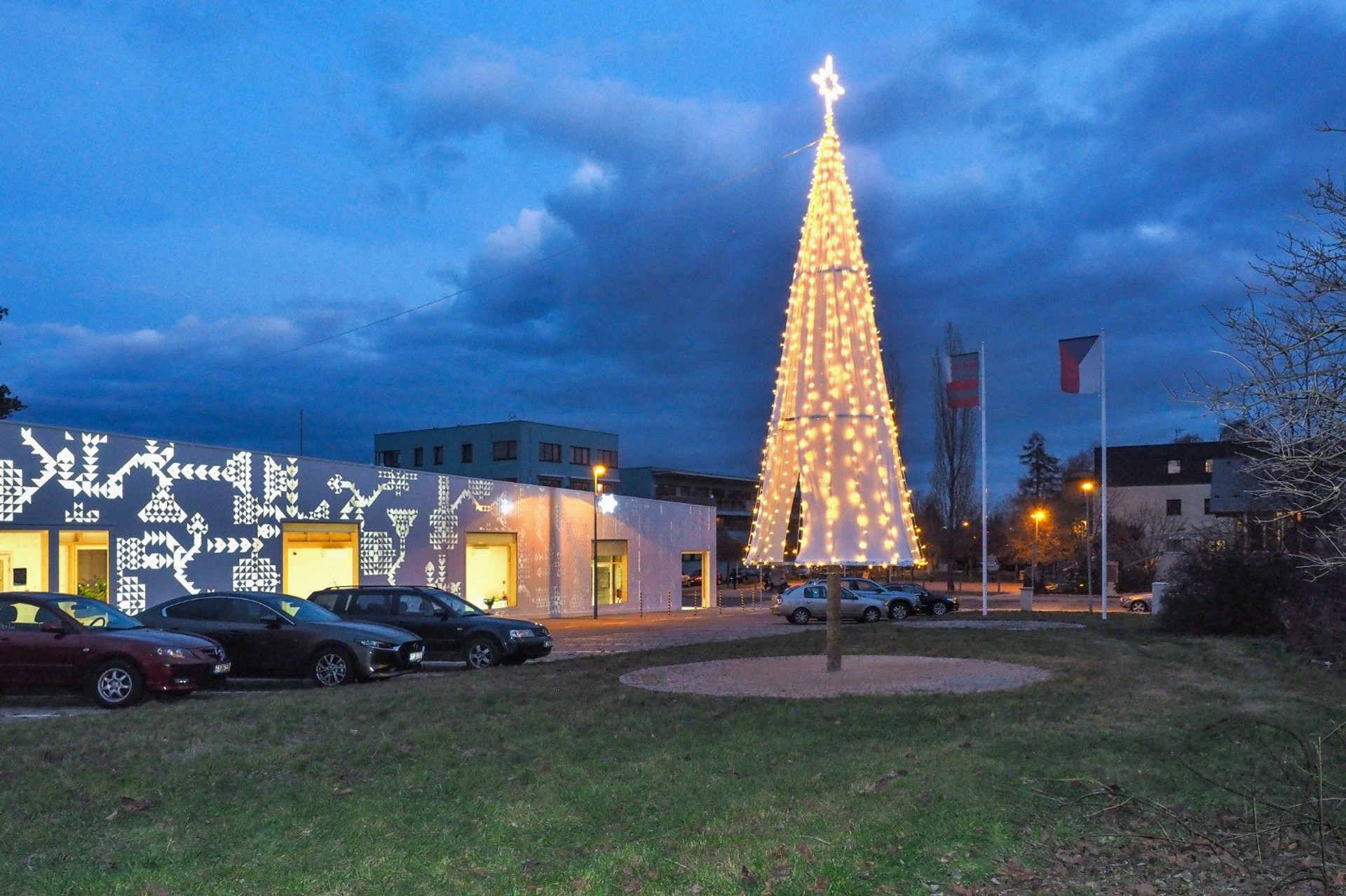 Festive tree and building exterior at dusk