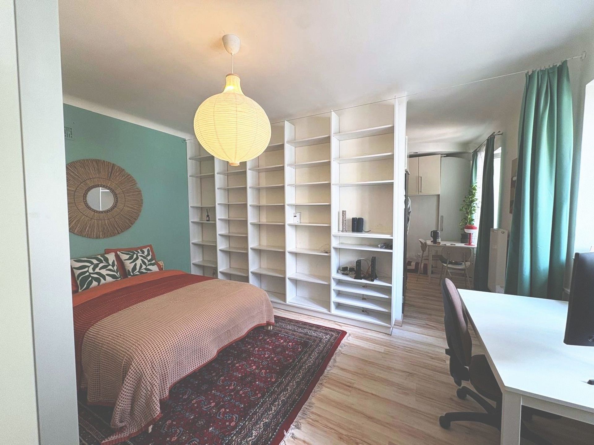 Bedroom with desk and bookshelves