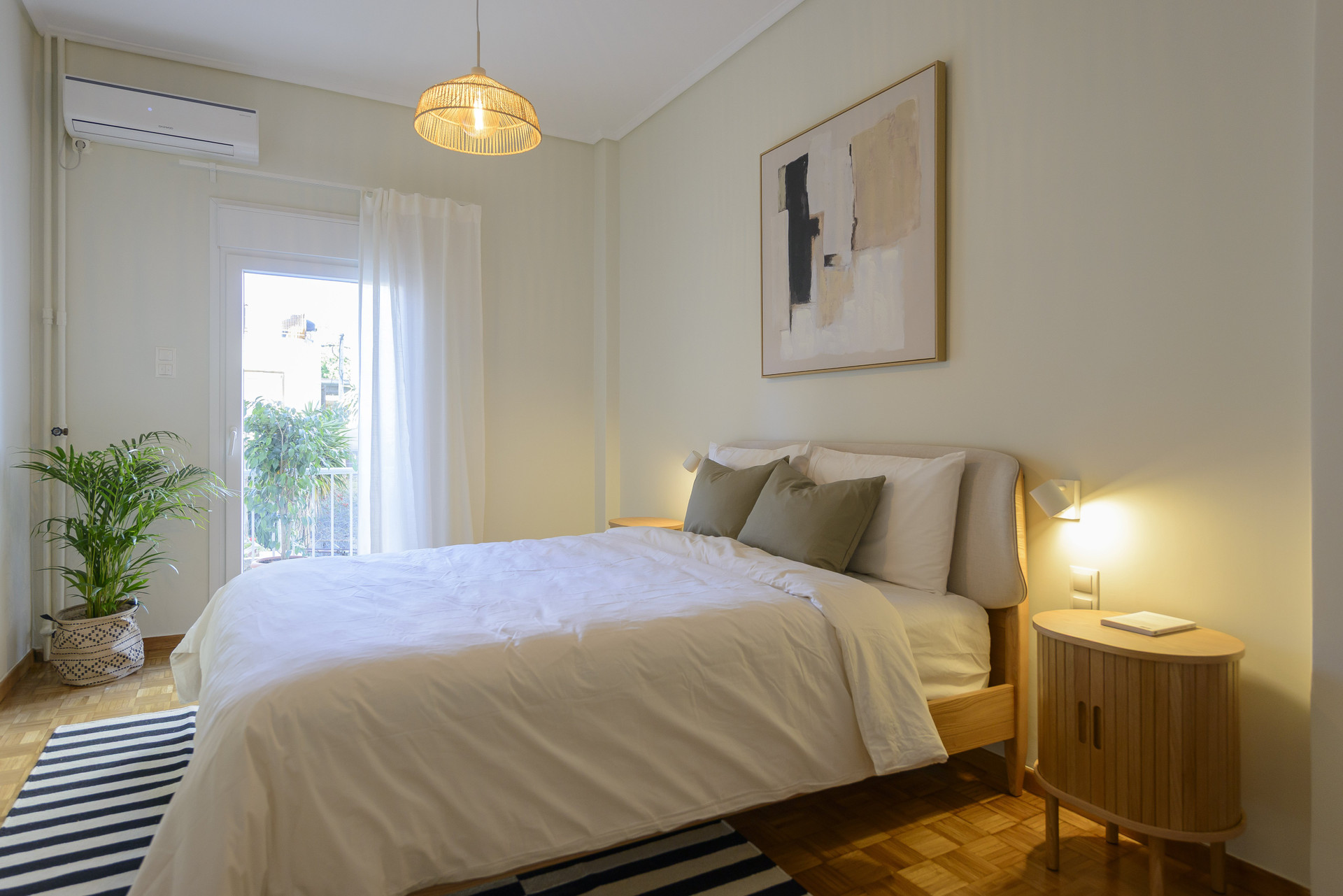 Bright bedroom with balcony access and natural morning light