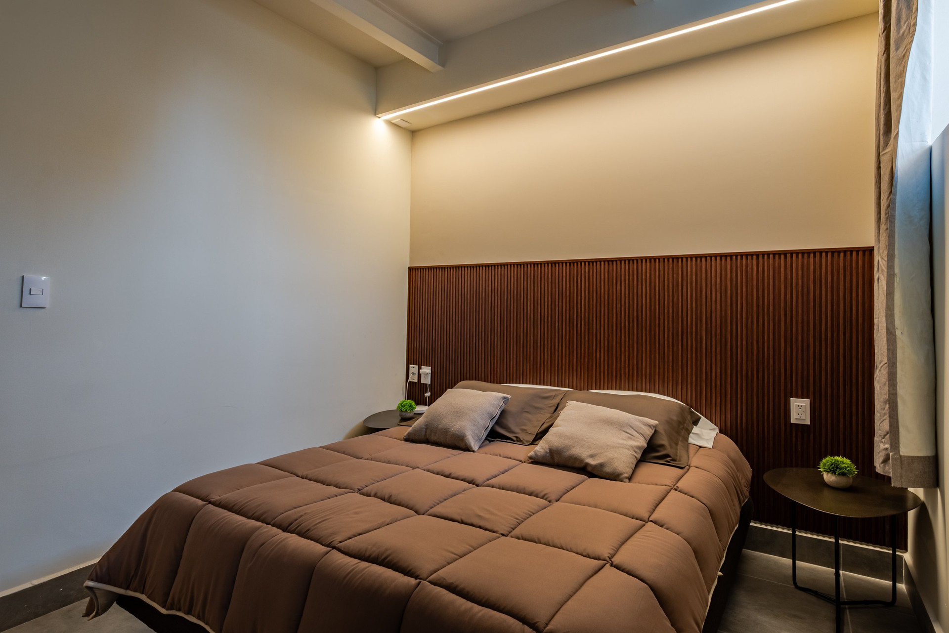 Bedroom with cozy bed and lamp