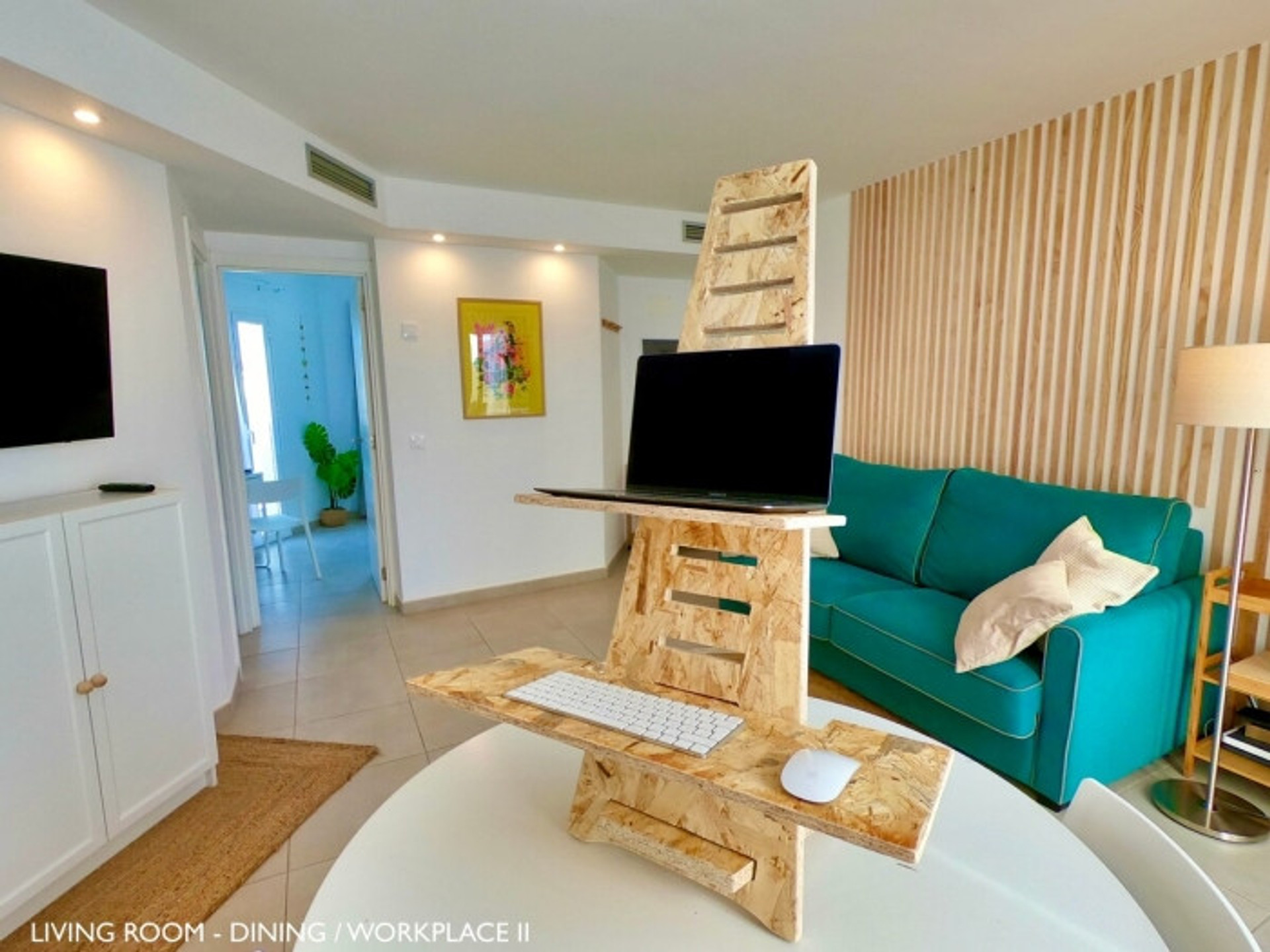 Living room with standing desk workspace