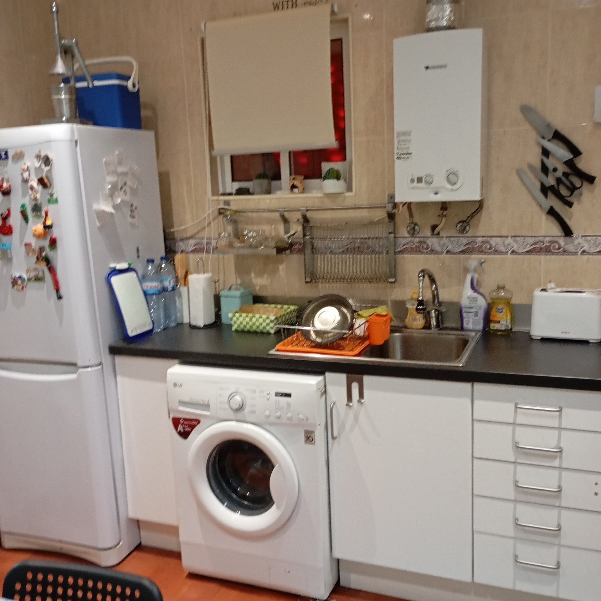 Kitchen with fridge and washer