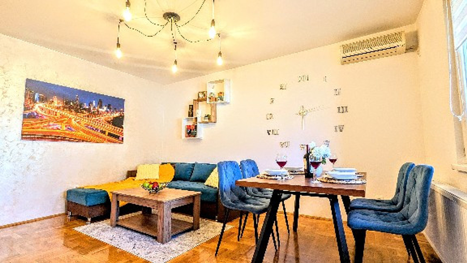 The living room is as spacious and bright as you can see in the picture. It is equipped with comfortable turquoise-green pull-out furniture, paintings, details that open up the space, a soft carpet, a table for storing things, a 35-inch plasma HD TV