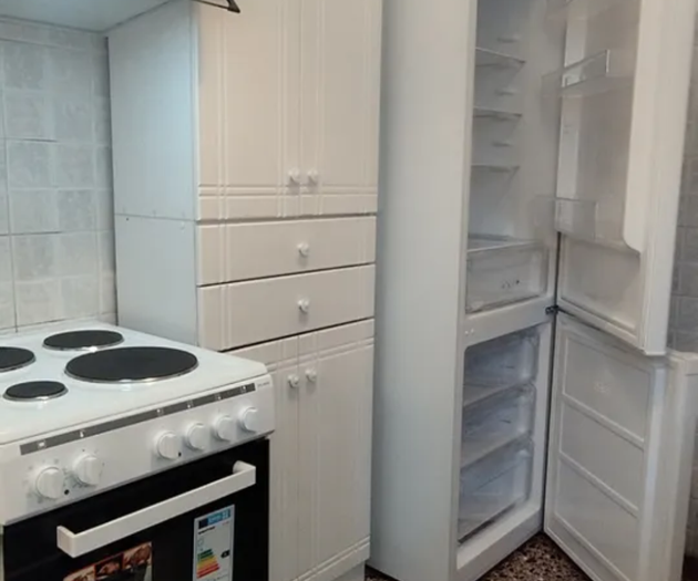 Kitchen stove and open fridge