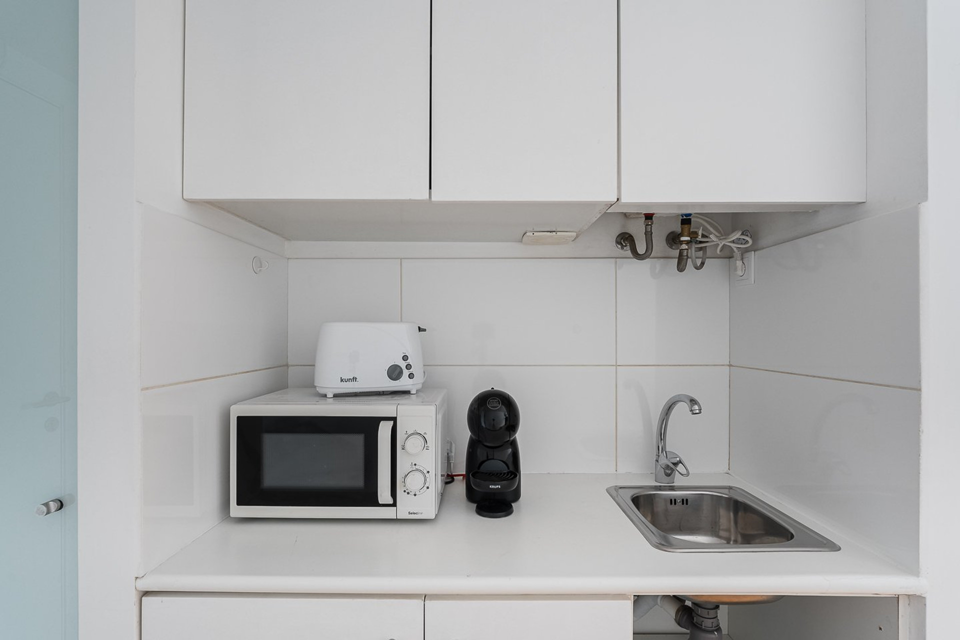 White kitchenette with appliances