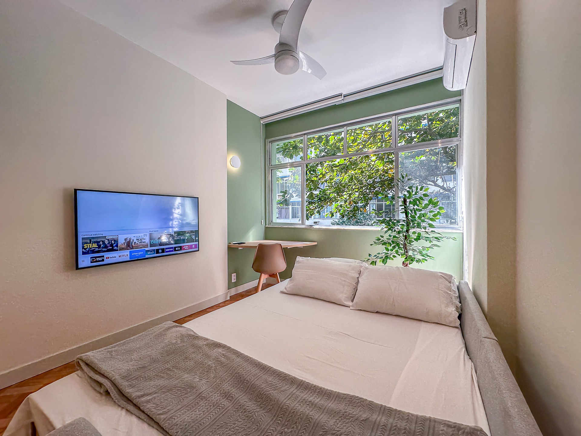 Bedroom with TV and window