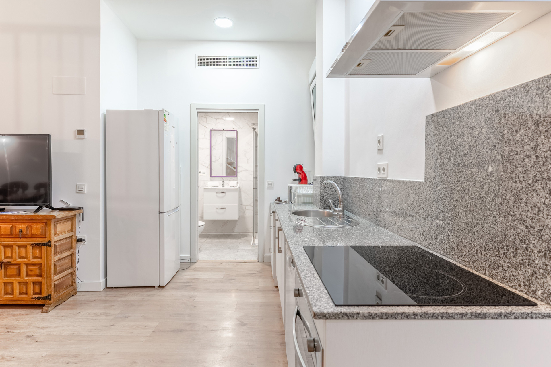 Kitchen leading to bathroom