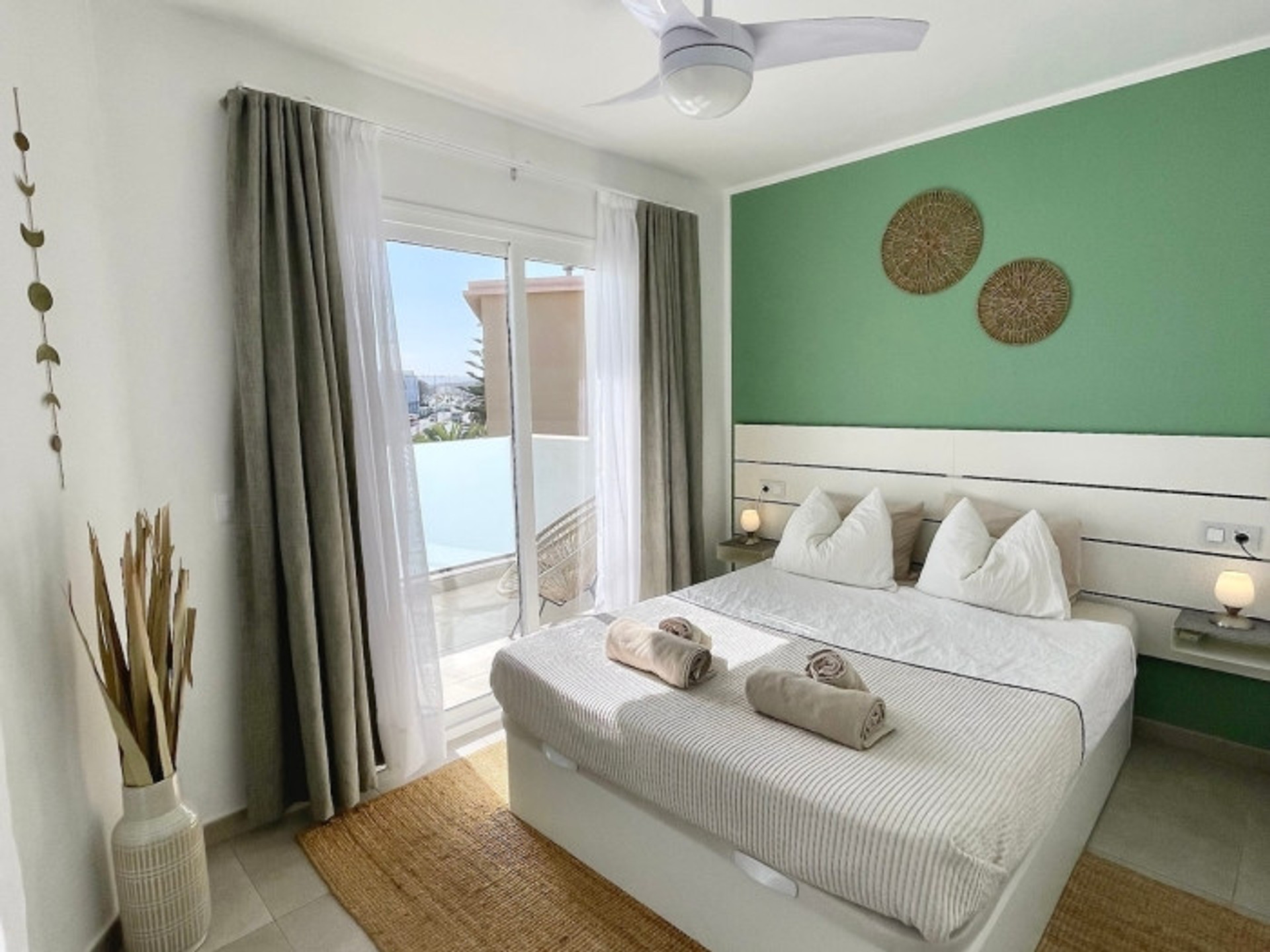 Bright bedroom with green accent wall