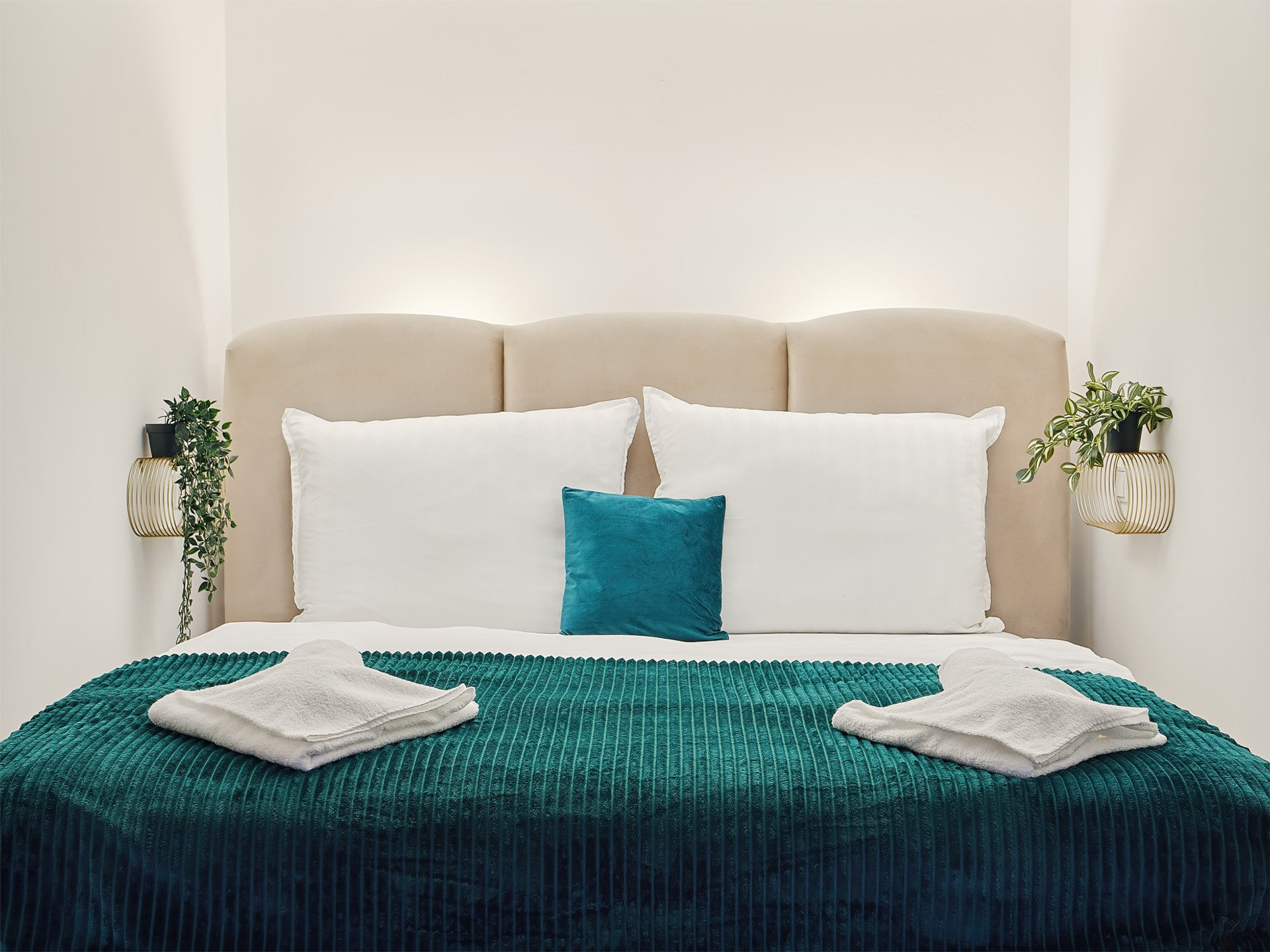 Double bed close-up with teal bedding
