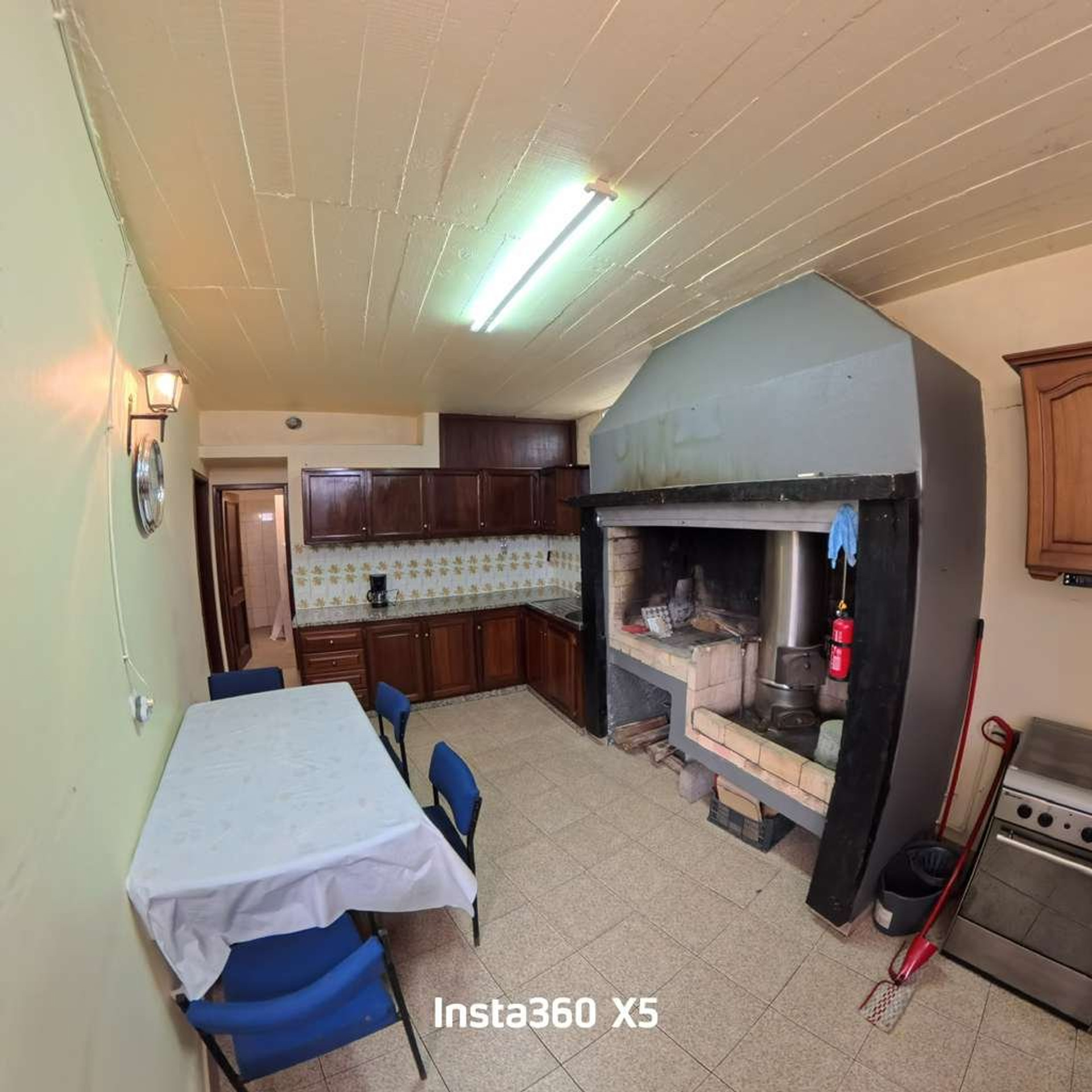 Kitchen with fireplace and dining table